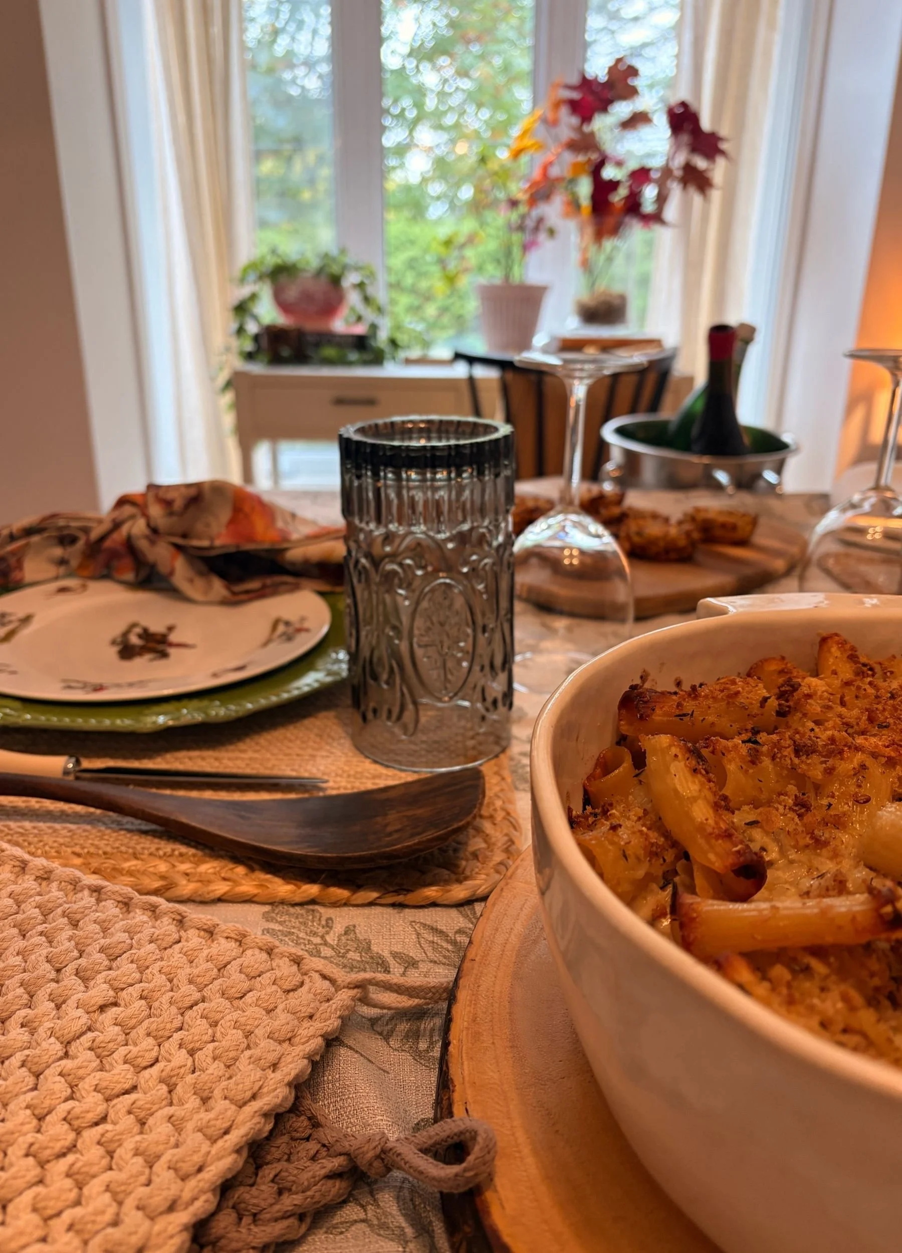 Homemade baked French onion pasta with a golden, crispy topping, served in a white casserole dish for Thanksgiving dinner at home.