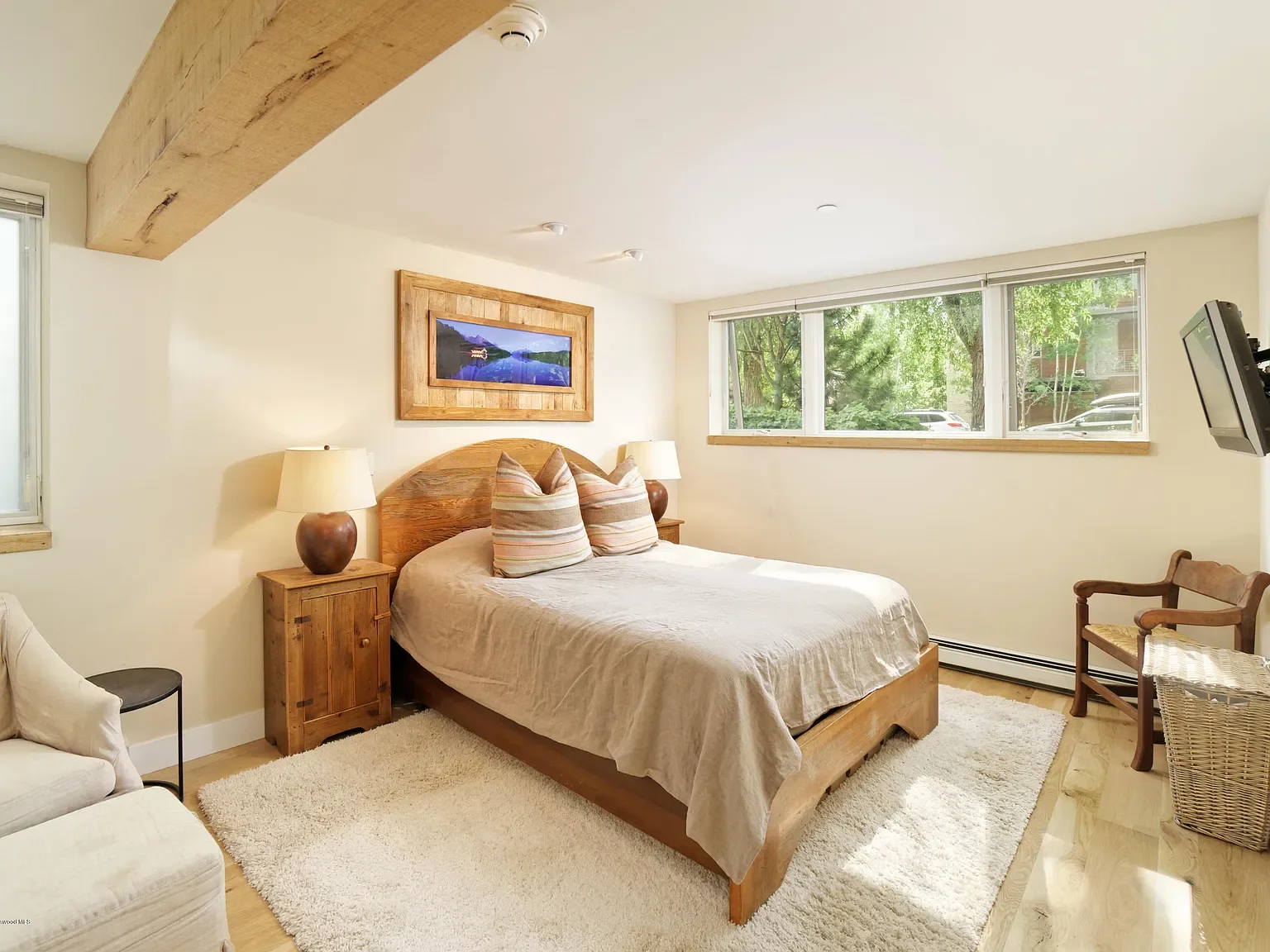 Cozy mountain bedroom featuring exposed timber beam in Aspen, Colorado.