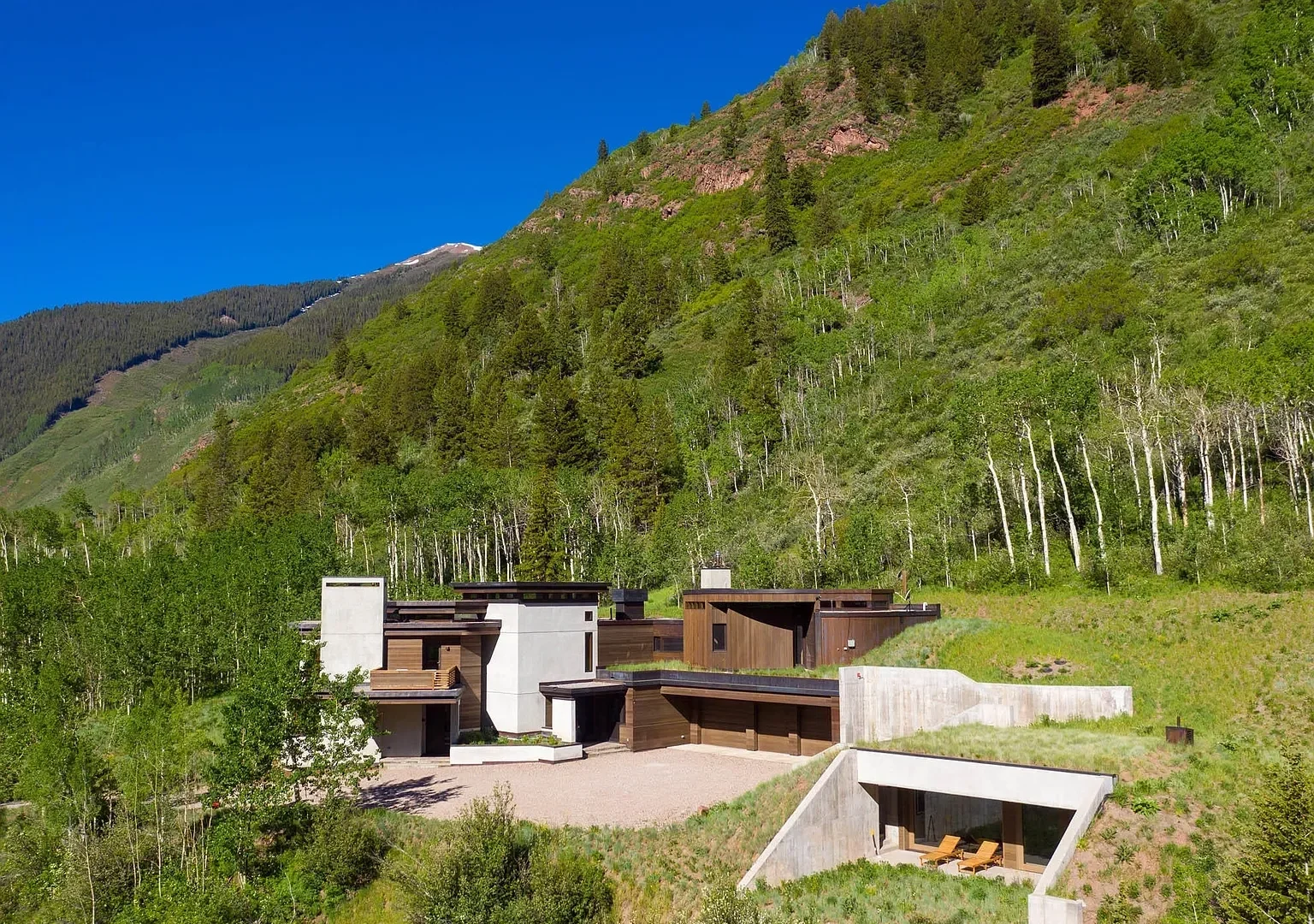 Modern residential home with terraced lawn nestled in the mountains built by Form 44 Construction near Conundrum Creek in Aspen, CO