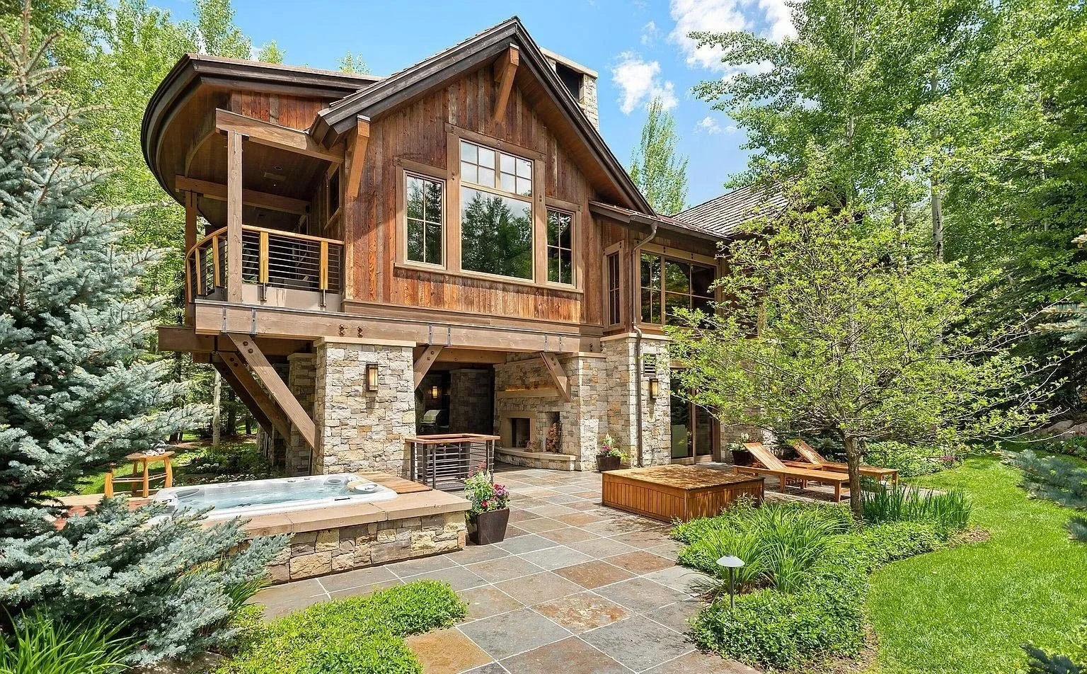A luxurious mountain home with a stone-surrounded hot tub and patio built by John Olson, owner of Form 44 Construction, on Crystal Lake Road in Aspen, Colorado 