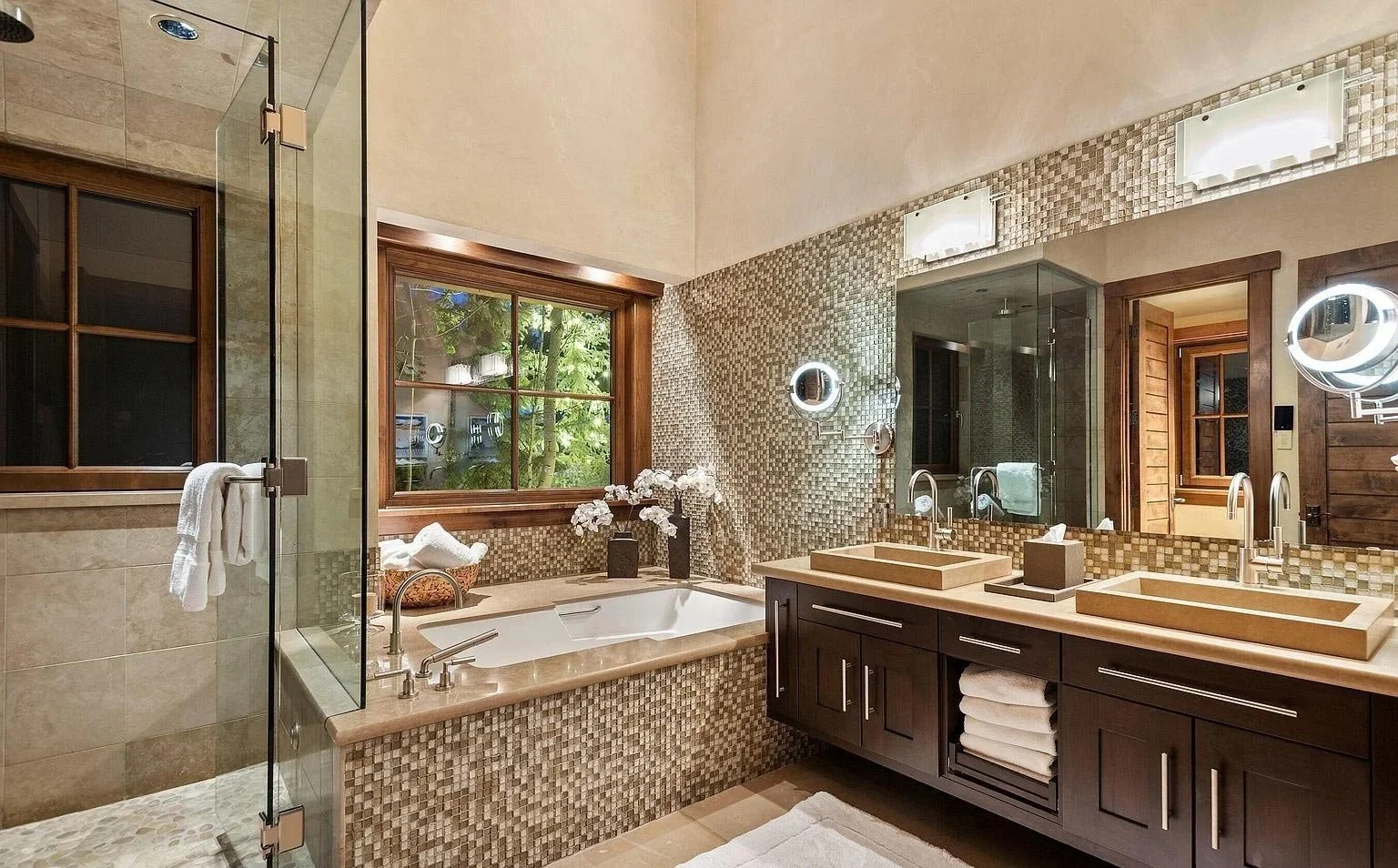 A spacious bathroom featuring intricate mosaic tiling, double sinks, a large tub, and glass-enclosed shower built by John Olson, owner of Form 44 Construction, on Crystal Lake Road in Aspen, Colorado.