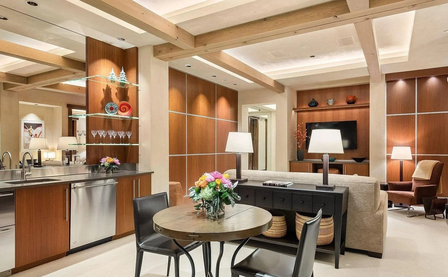 A modern wet bar and sitting area with wooden  beams which tastefully accent the ceiling and complement the structure of the room built by John Olson, owner of Form 44 Construction, on Crystal Lake Road in Aspen, Colorado.