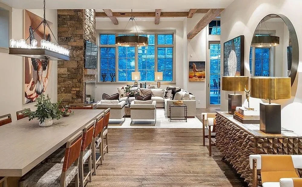 A bright and spacious modern living room featuring stone wall accents and wooden beams along the ceiling built by John Olson, owner of Form 44 Construction, on Ute Avenue in Aspen, Colorado