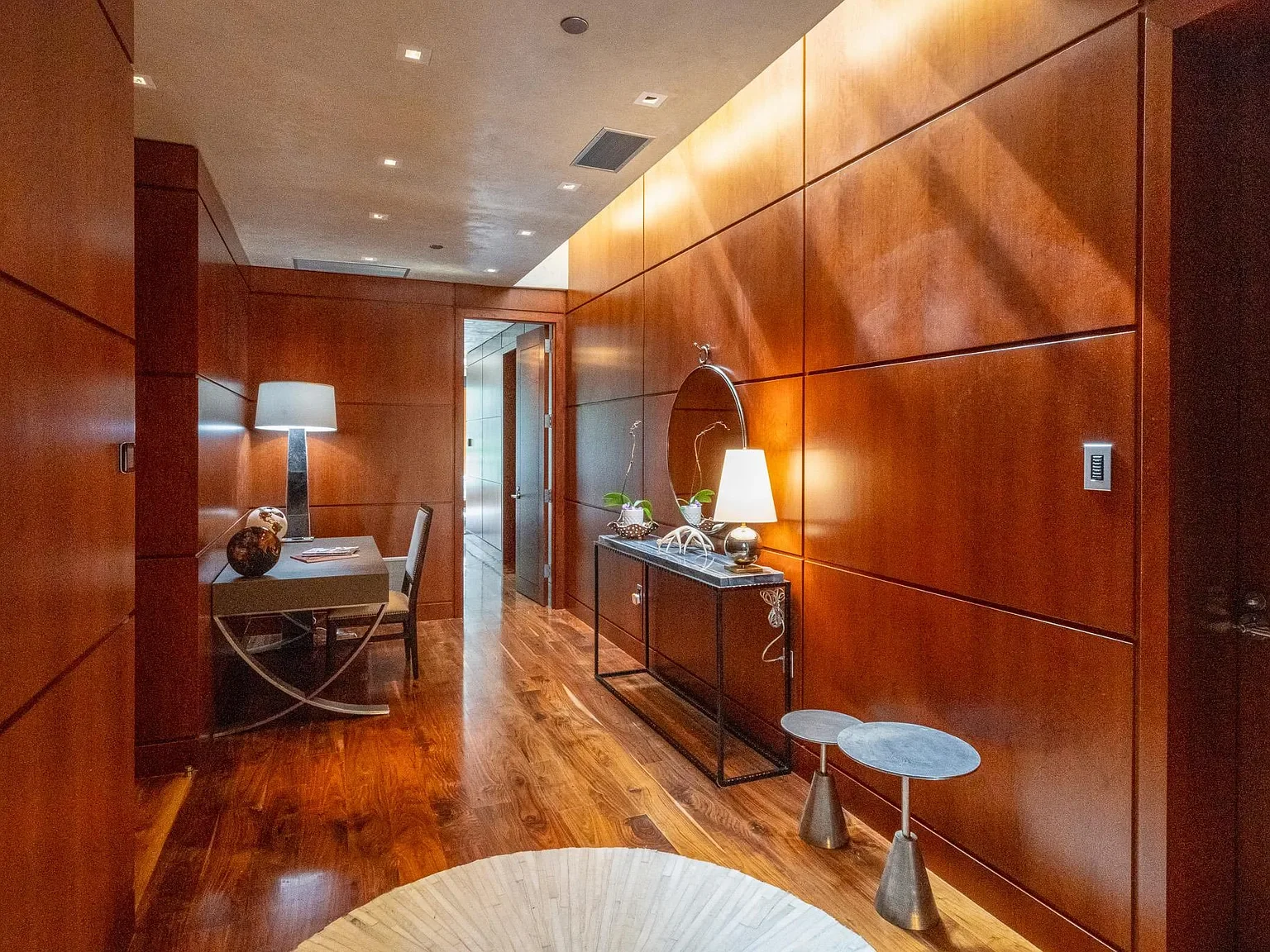 Rich architectural wood paneling and hardwood floors mark the entryway of The Mother Lode in Aspen, Colorado.