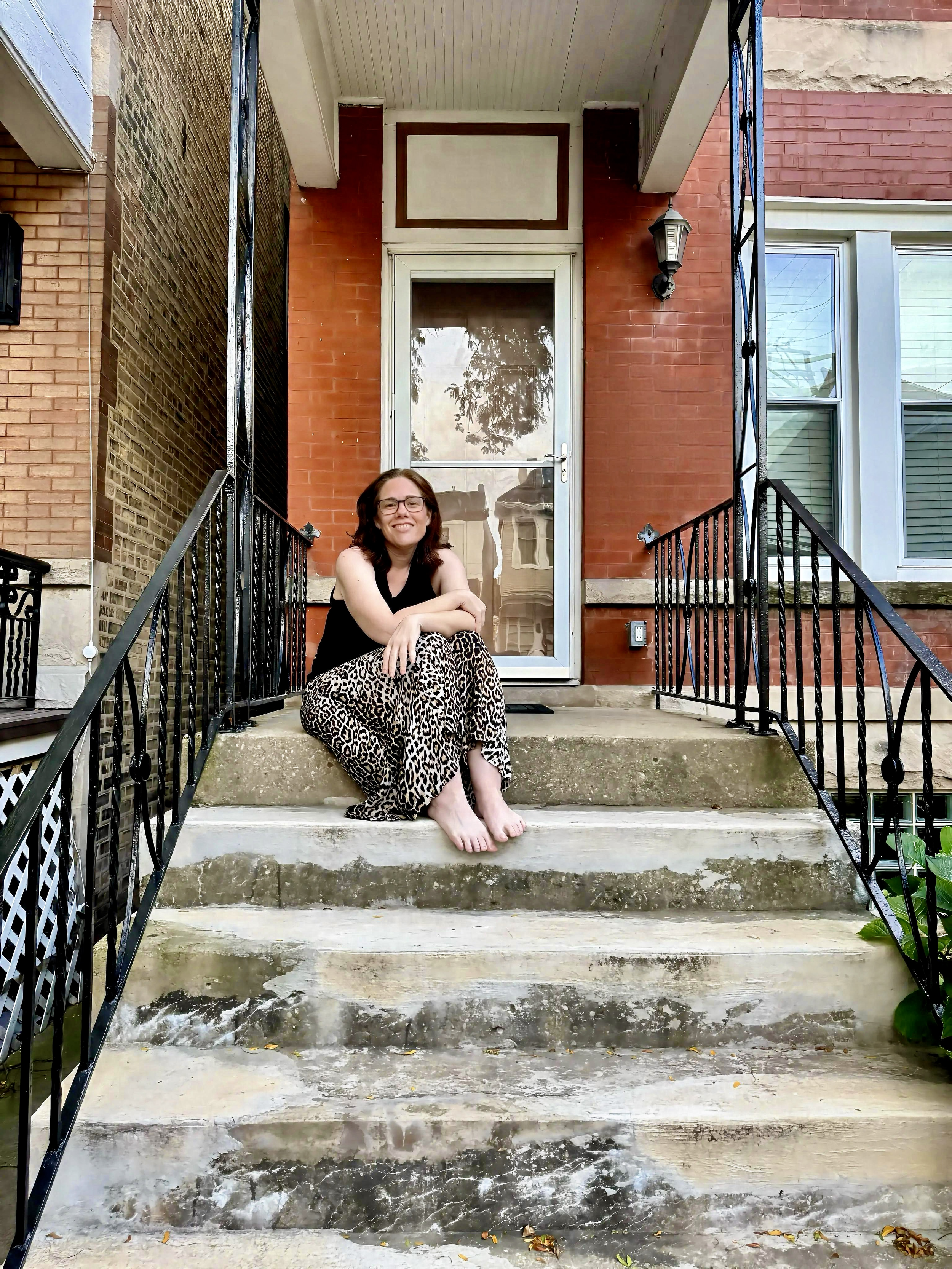 Briana J Watson on the front steps of her house.