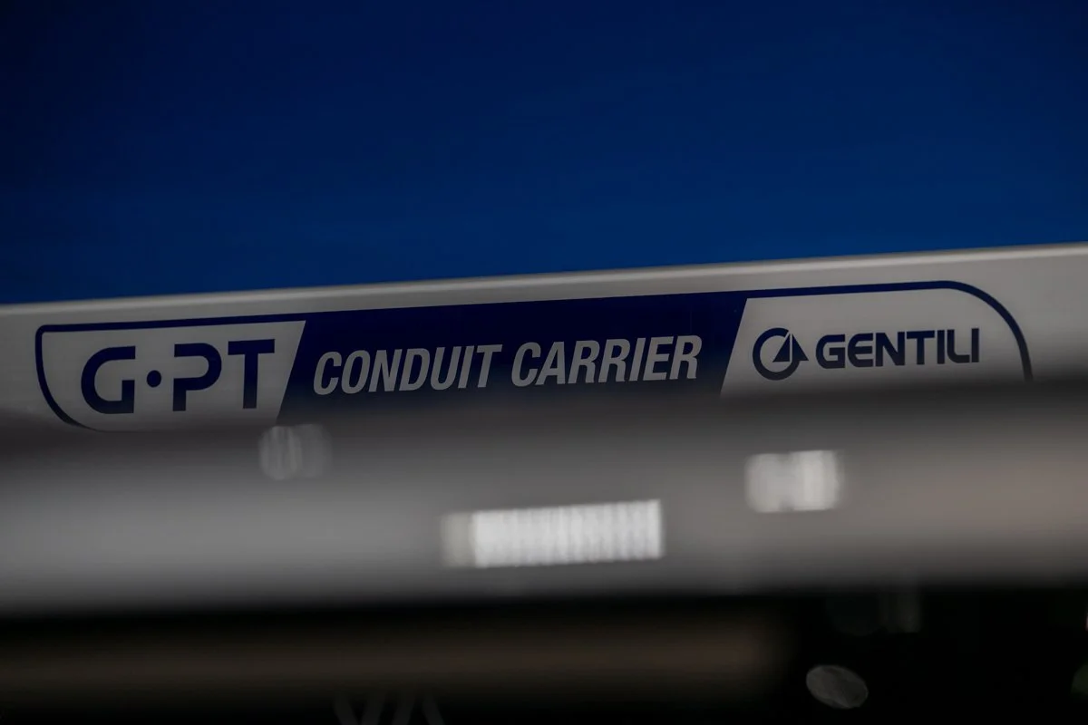 Close-up of a sign that reads "G.P.T CONDUIT CARRIER GENTILI" on a metallic surface.