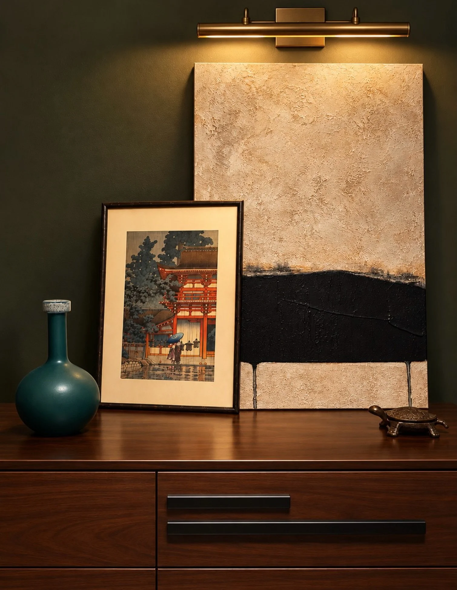 Great design is all about the unexpected pairings.

An original Japanese woodblock print is juxtaposed against a bold, modern abstract painting, creating a beautiful contrast of artistic styles, textures, and eras. A sculptural teal vase adds a welco