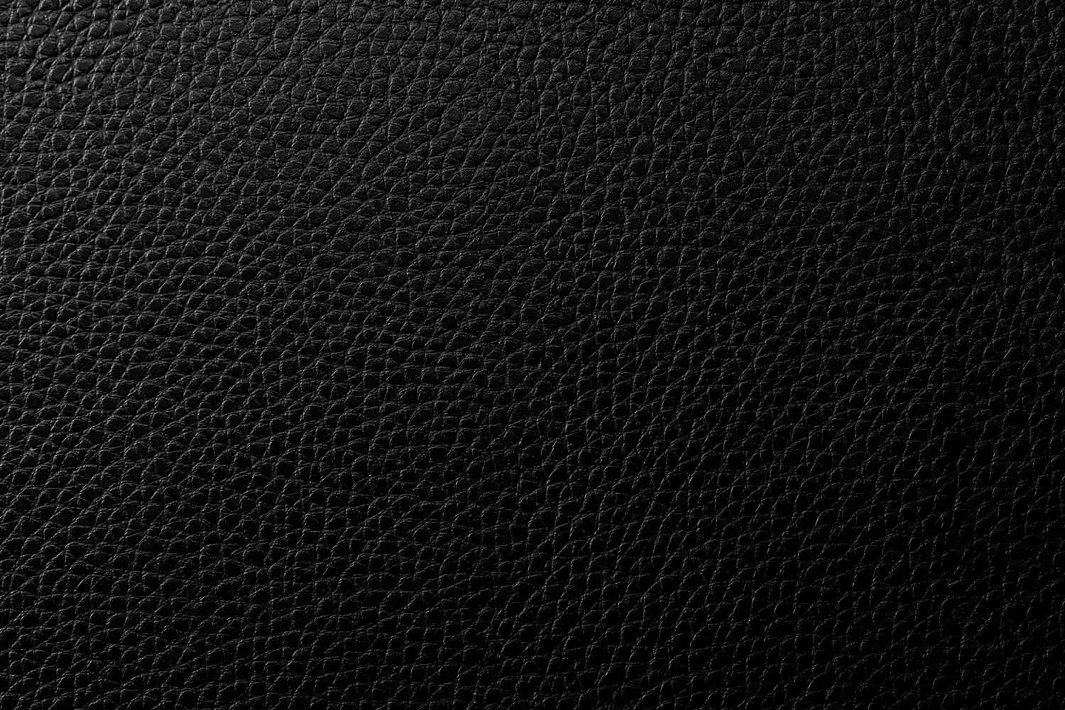 Close-up of black textured leather surface.