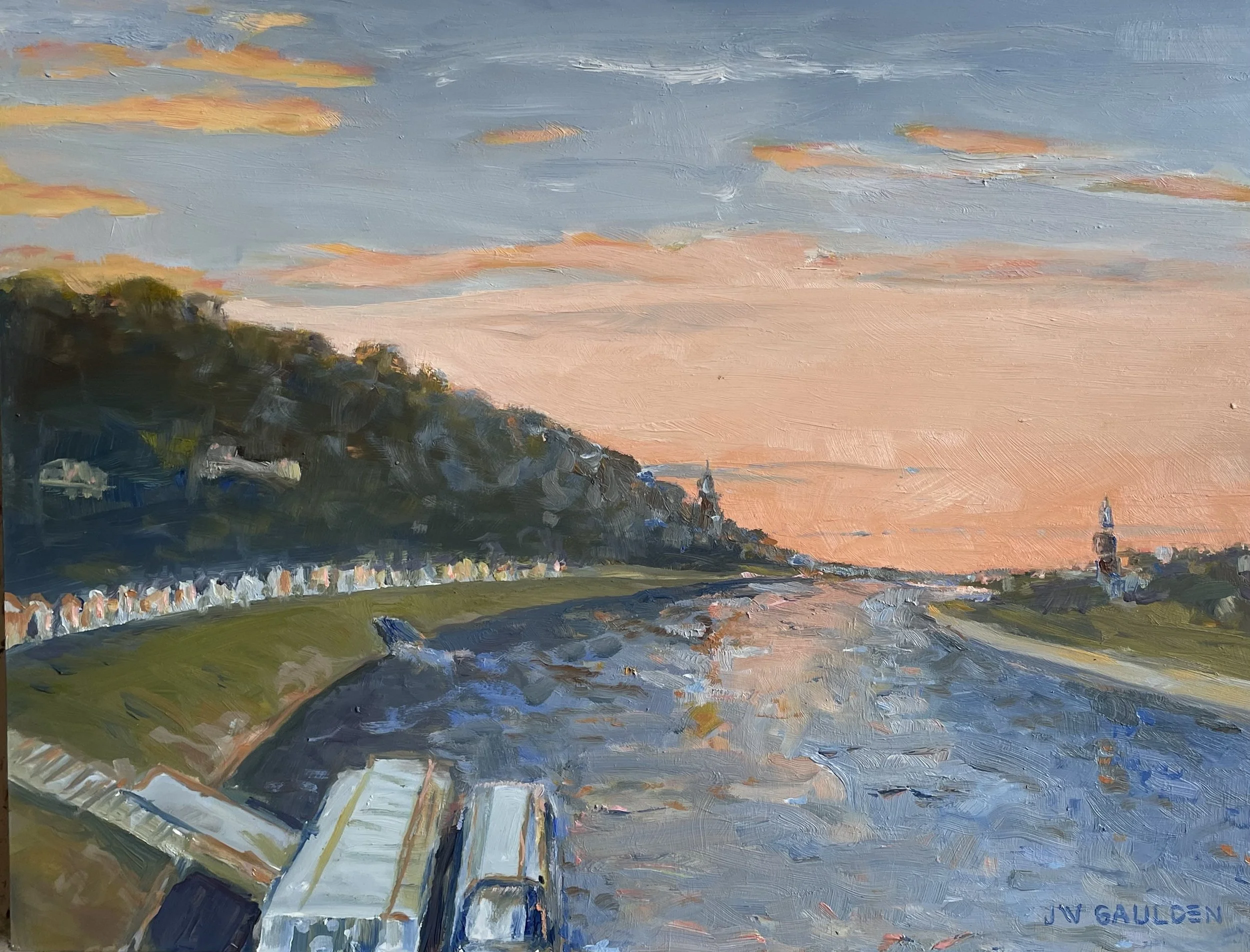 A landscape painting of a sunset with colorful clouds, green hills, a body of water, and a sailboat with a billowing white sail.