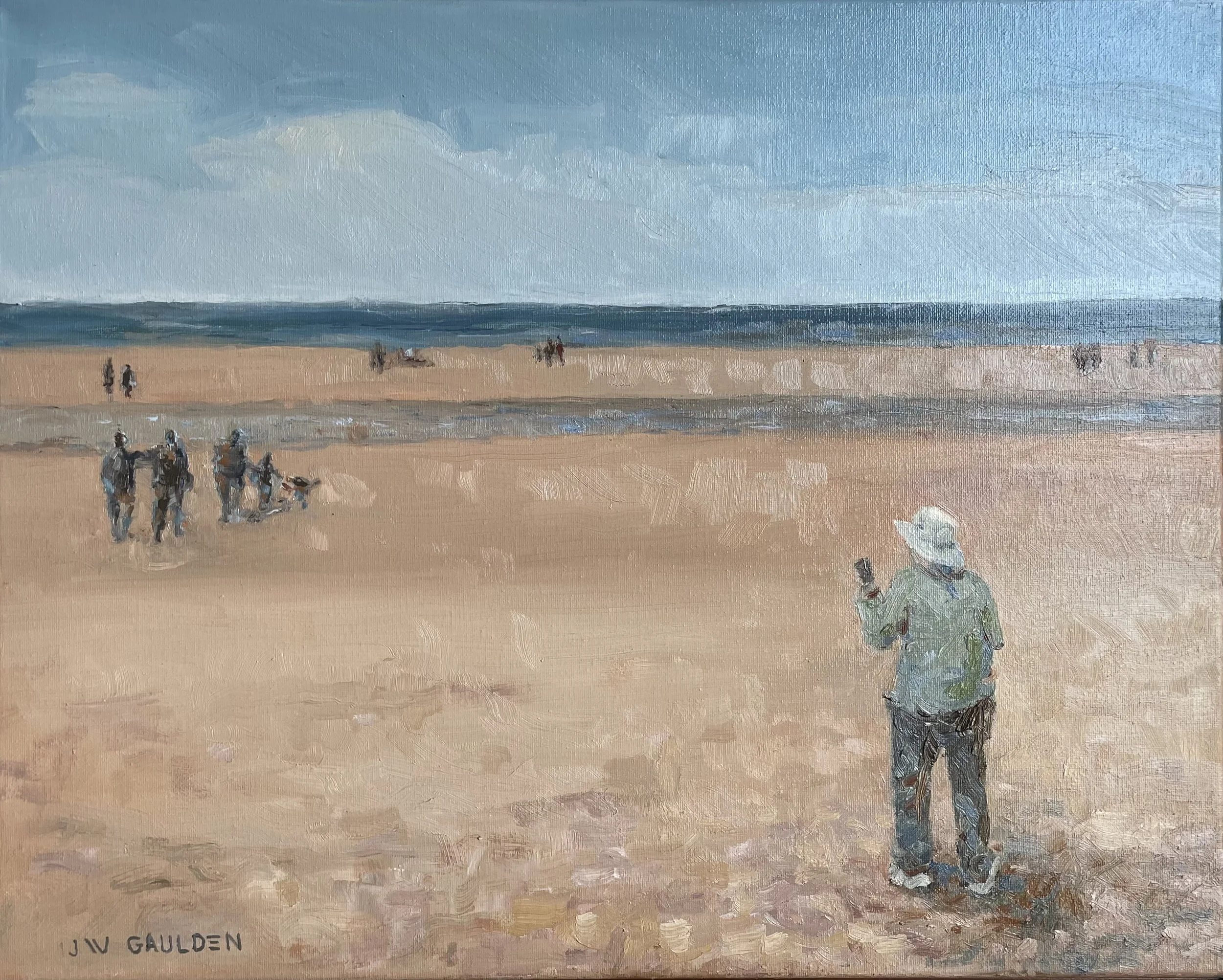 A painting of a beach scene with a person walking on the sand wearing a patterned shirt and a hat. Several groups of people are seen in the distance near the shoreline, with waves approaching the shore. The sky is partly cloudy.
