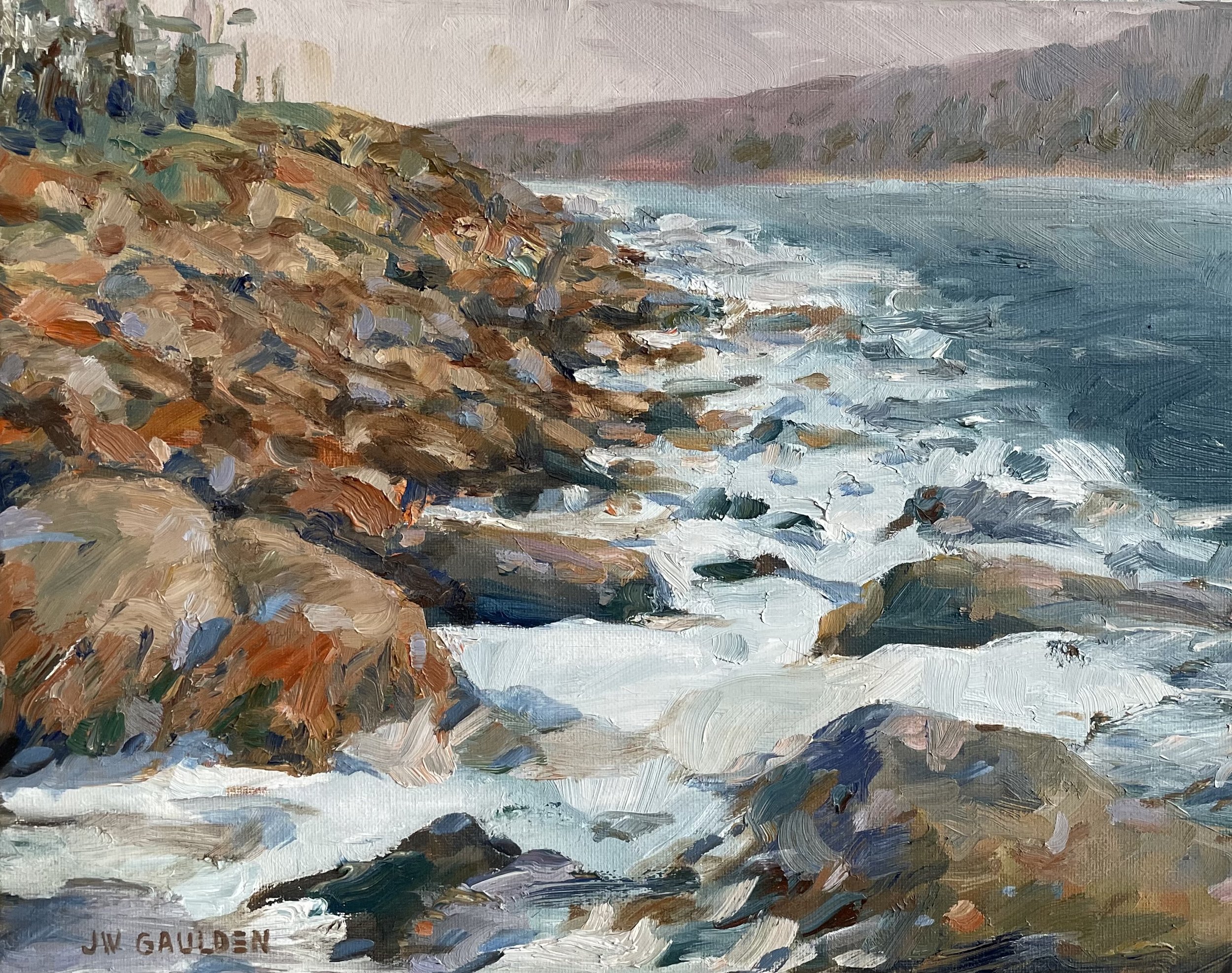 Oil painting of a rocky shoreline with ocean waves crashing against the rocks, and distant hills or mountains in the background.