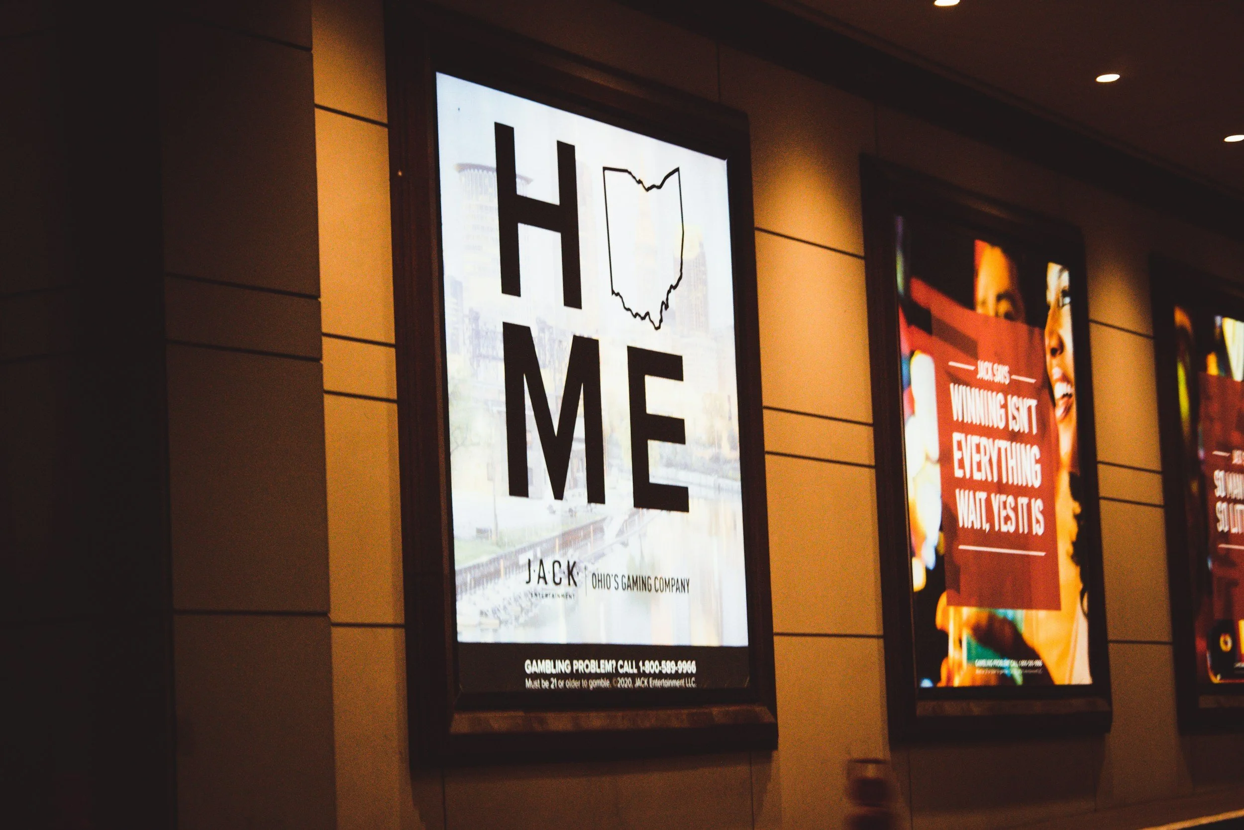 Sign spelling 'Home' featuring an Ohio state outline as the letter O.