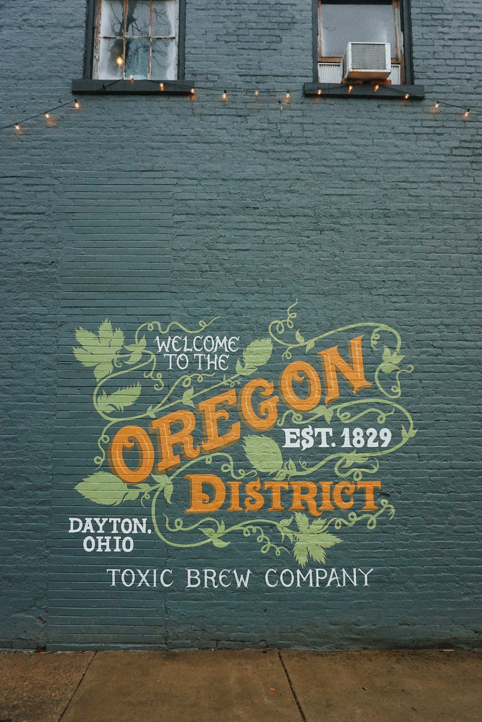 Painted sign on an exposed painted brick building in the historic Oregon District entertainment neighborhood in Dayton, Ohio.