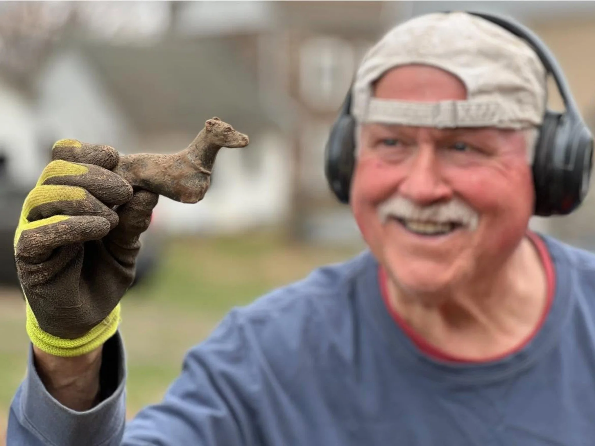 DogTag Doug From Quarter Hoarder Holding a Brass Legless Dog Figuring He Found Metal Detecting
