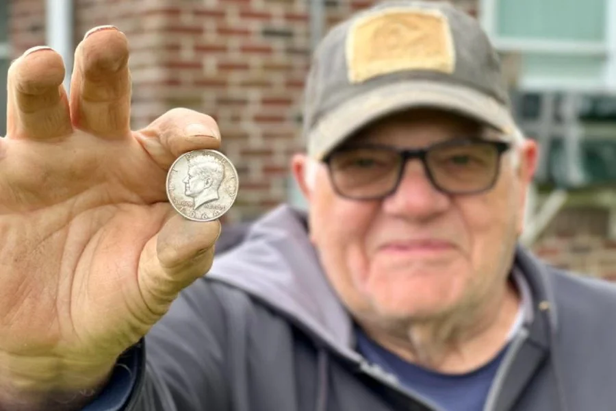Charley the Heritage Relic Hunter from Quarter Hoarder holding a 1964 silver John F Kennedy Half Dollar he found metal detecting
