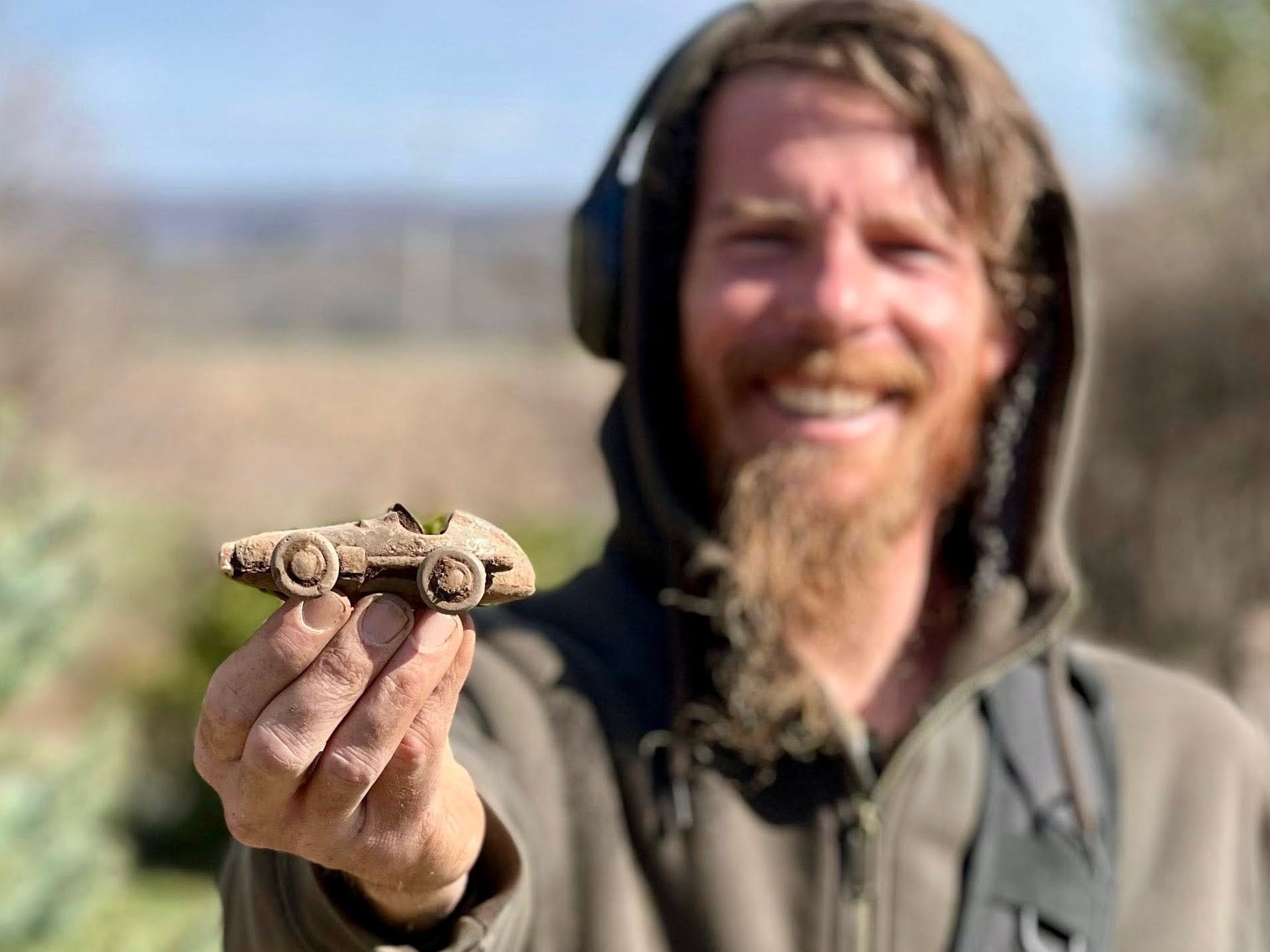 Rich VanWinkle from Quarter Hoarder holding a 1930's toy car found metal detecting
