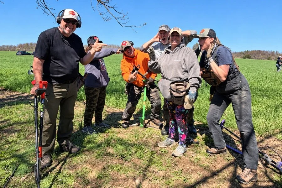 Bre the Metal BREtectorist from Quarter Hoarder posing with a group of friends about to metal detect an old field
