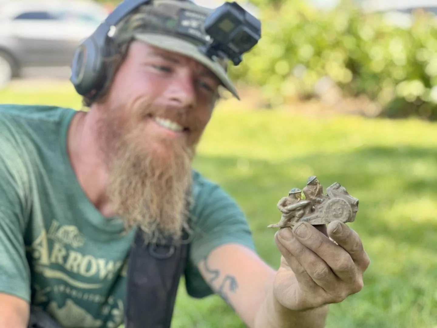 Rich VanWinkle from Quarter Hoarder holding a lead Barclay toy tank with two soldiers on it found metal detecting a 1700s home