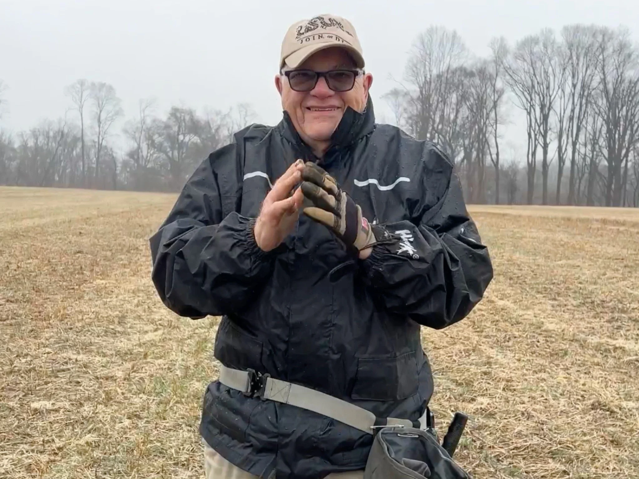 Charley From Quarter Hoarder Standing in a Field After Finding an 18k Gold Ring With a Red Ruby Stone