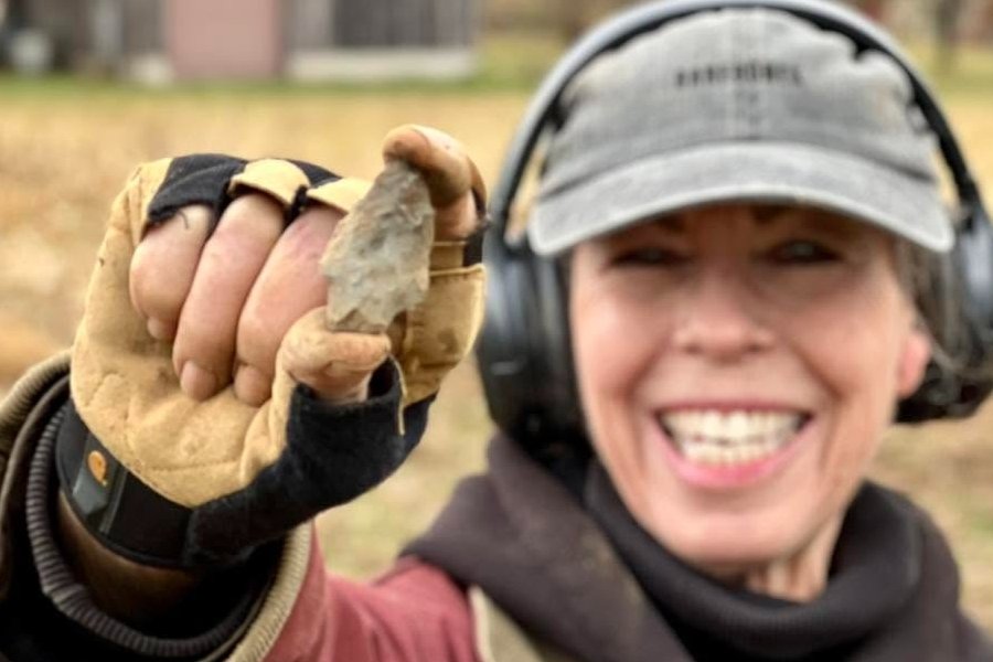 Lynne from Quarter Hoarder holding a native american arrowhead she found while metal detecting