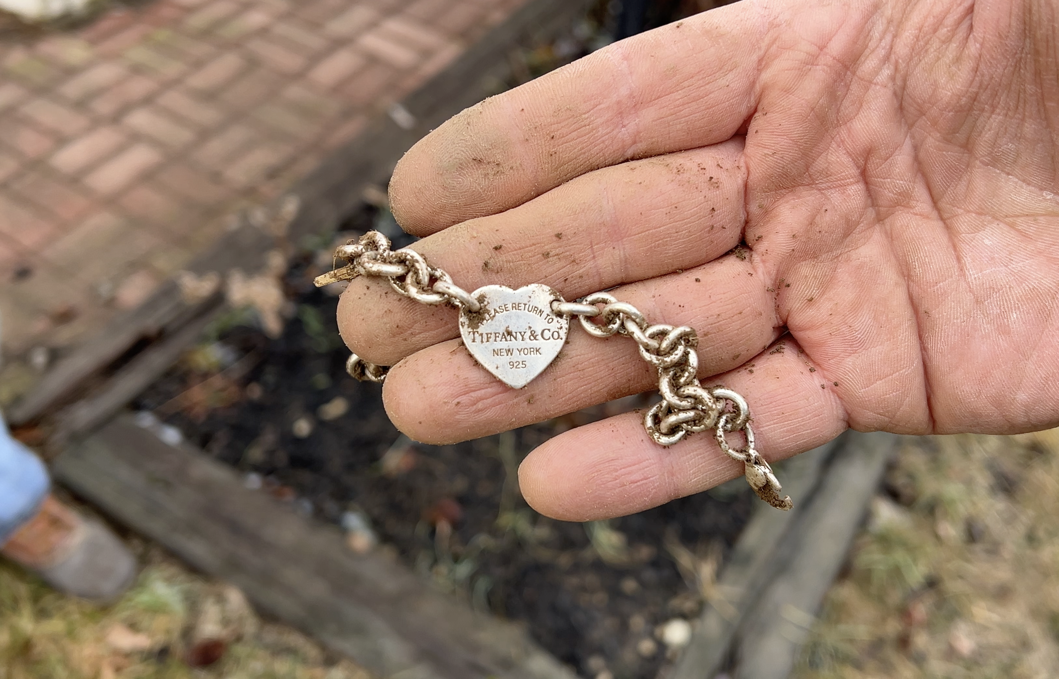 Lightly brushes off Tiffany Bracelet being returned to the owner after being found by Quarter Hoarder