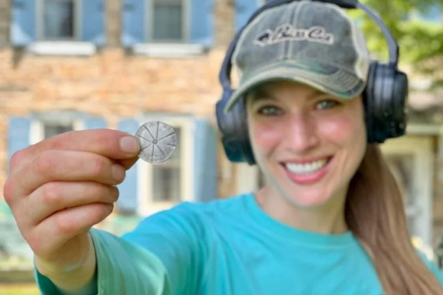 Jessica from Quarter Hoarder holding a rare 1700's Spanish Silver Two Reales she found metal detecting that has been scored and ready to be broken into pieces or eight.