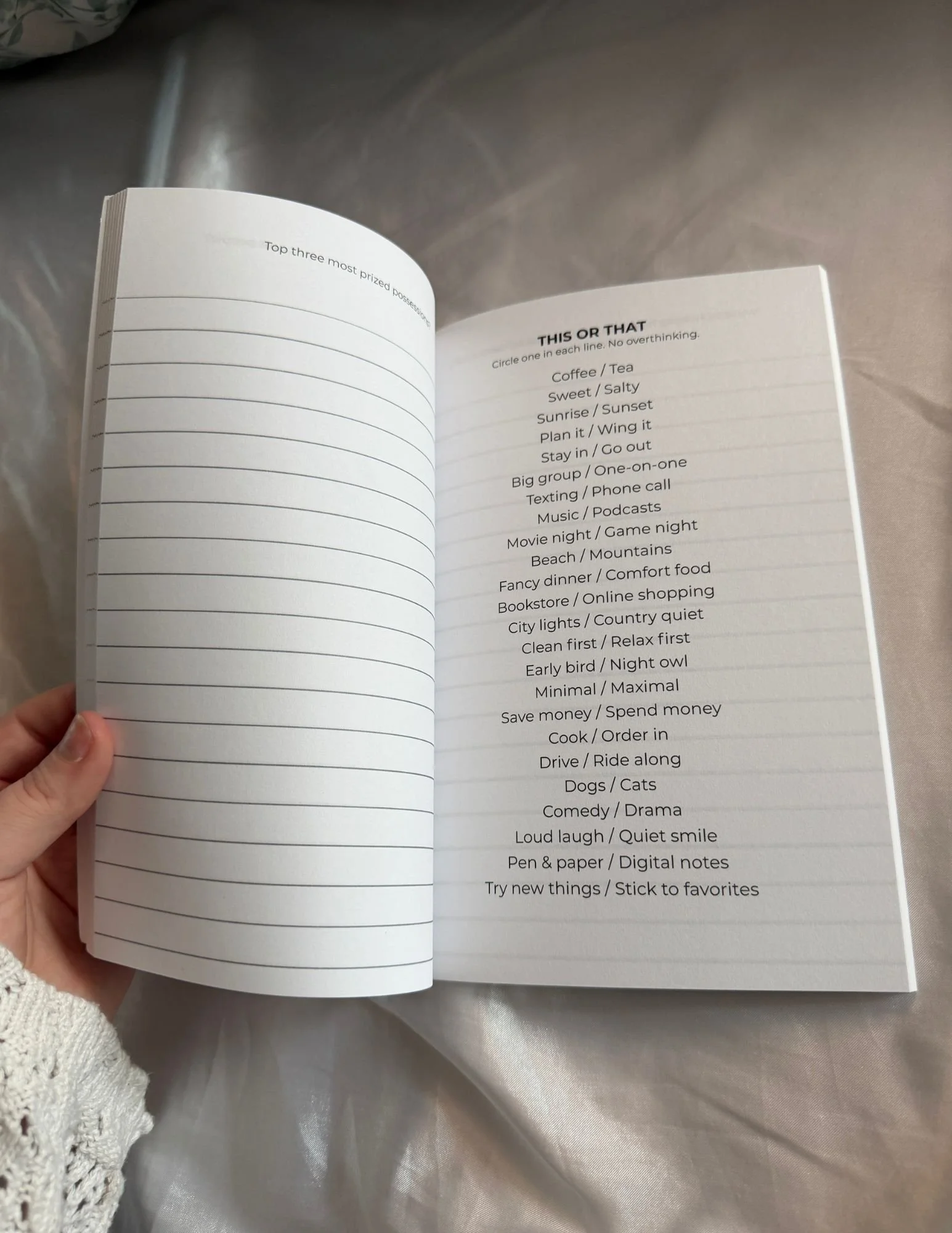 Open guided journal showing personal preference questions beside a lined response page.