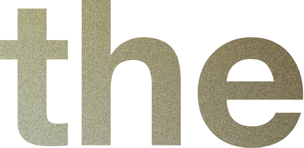 Close-up of a textured metallic sign with the word 'the' in lowercase letters.