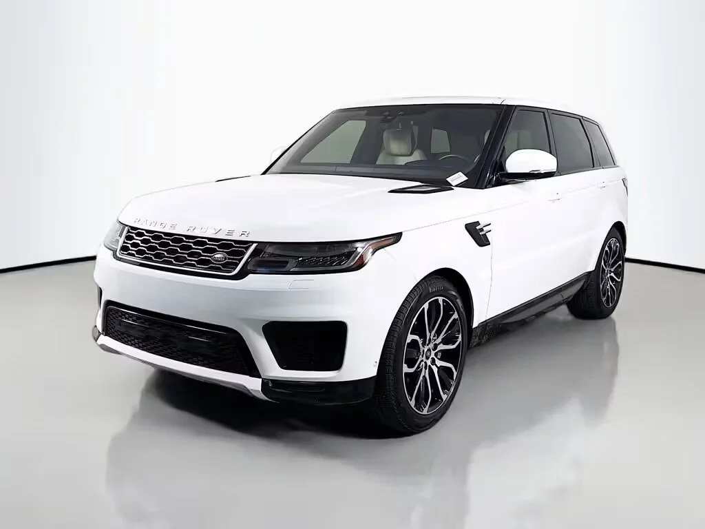 White Range Rover SUV parked in a showroom with a plain white background.
