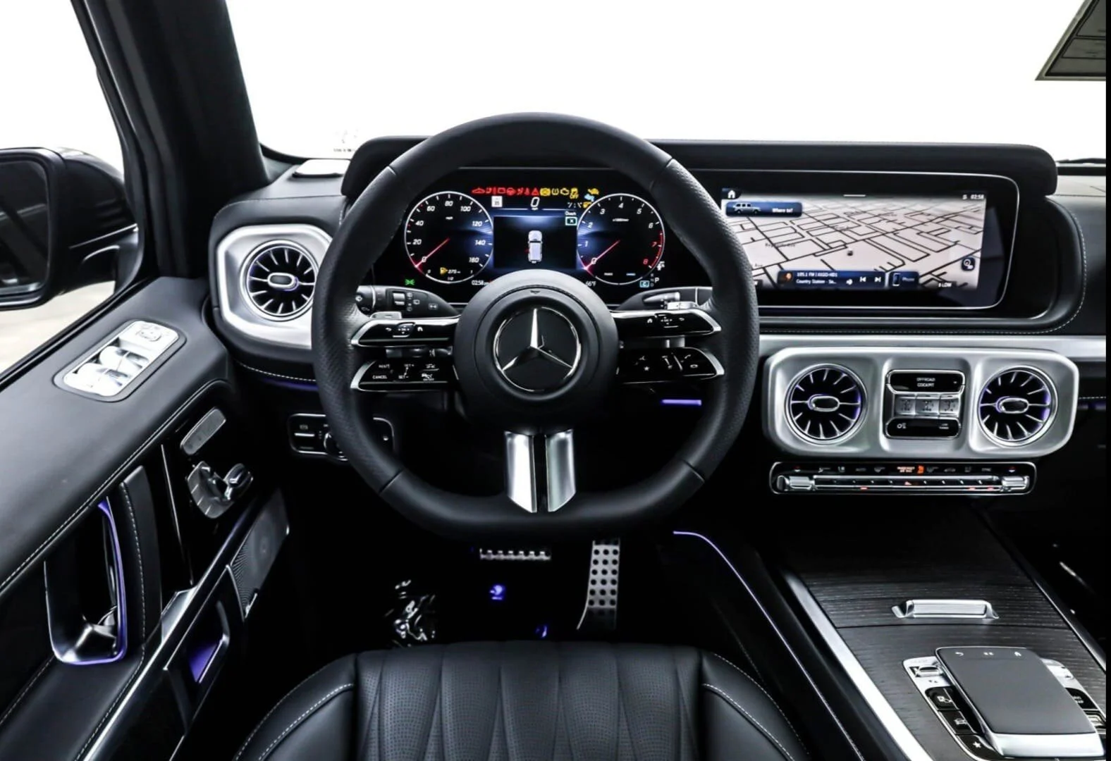 Inside view of a luxury Mercedes-Benz vehicle dashboard showcasing a steering wheel, digital instrument cluster, and infotainment screens with navigation.