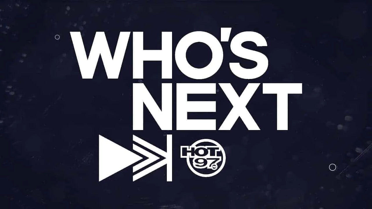 Text reading "WHO'S NEXT" with a logo of HOT 97 and arrow symbols pointing right, on a dark background.