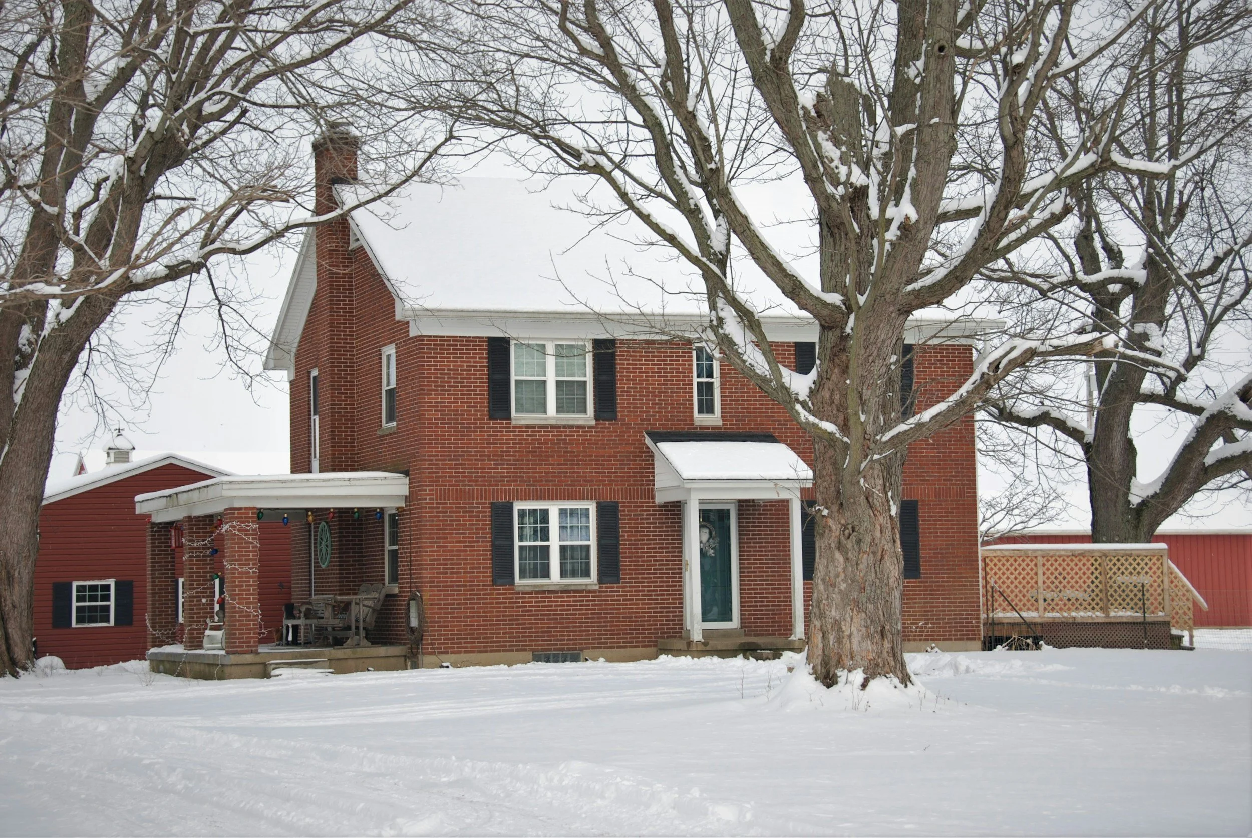 Red brick house covered in snow
