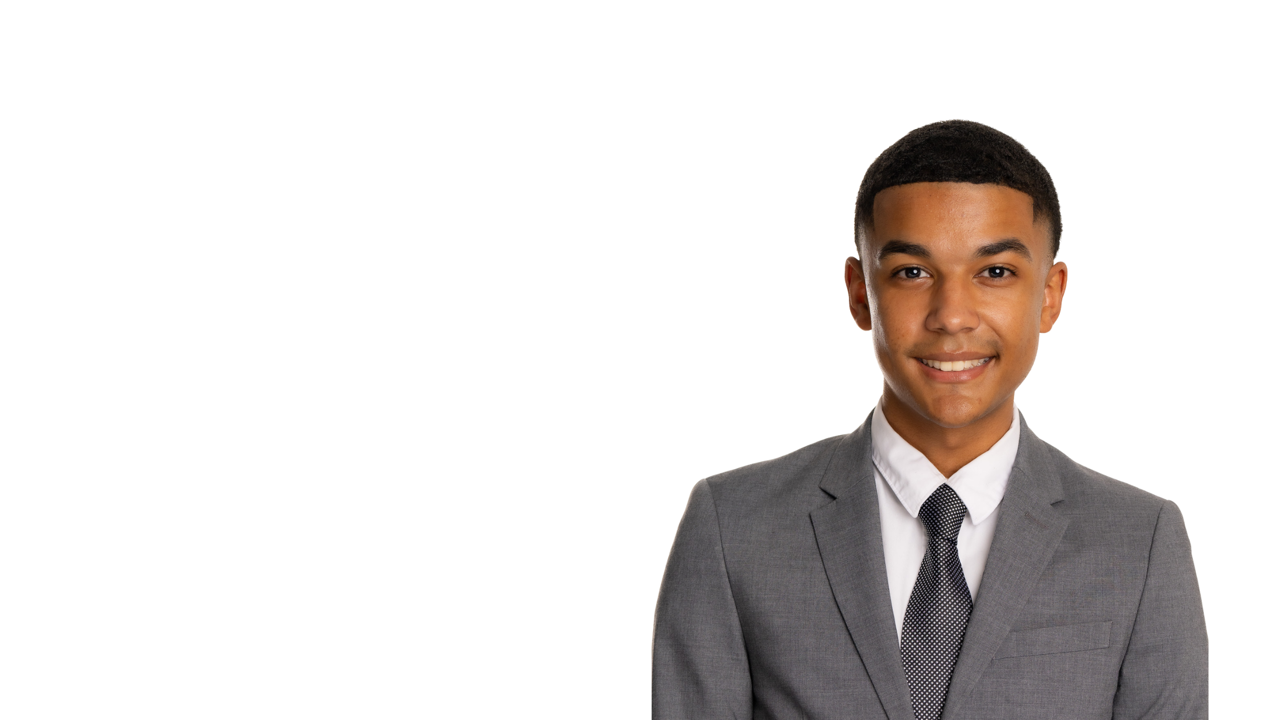 Isaiah Jobe-Winn in a gray suit smiling against a white background.