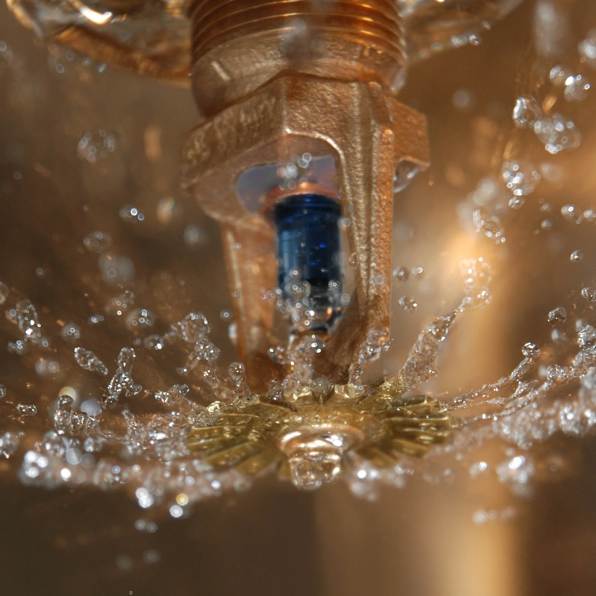 Close-up of a rusted screw partially submerged in liquid with bubbles.