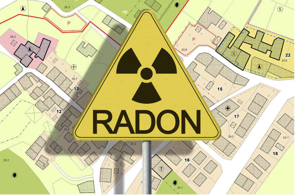 A yellow triangular warning sign with the radiation hazard symbol and the word 'RADON' superimposed on a colorful map of a residential area.