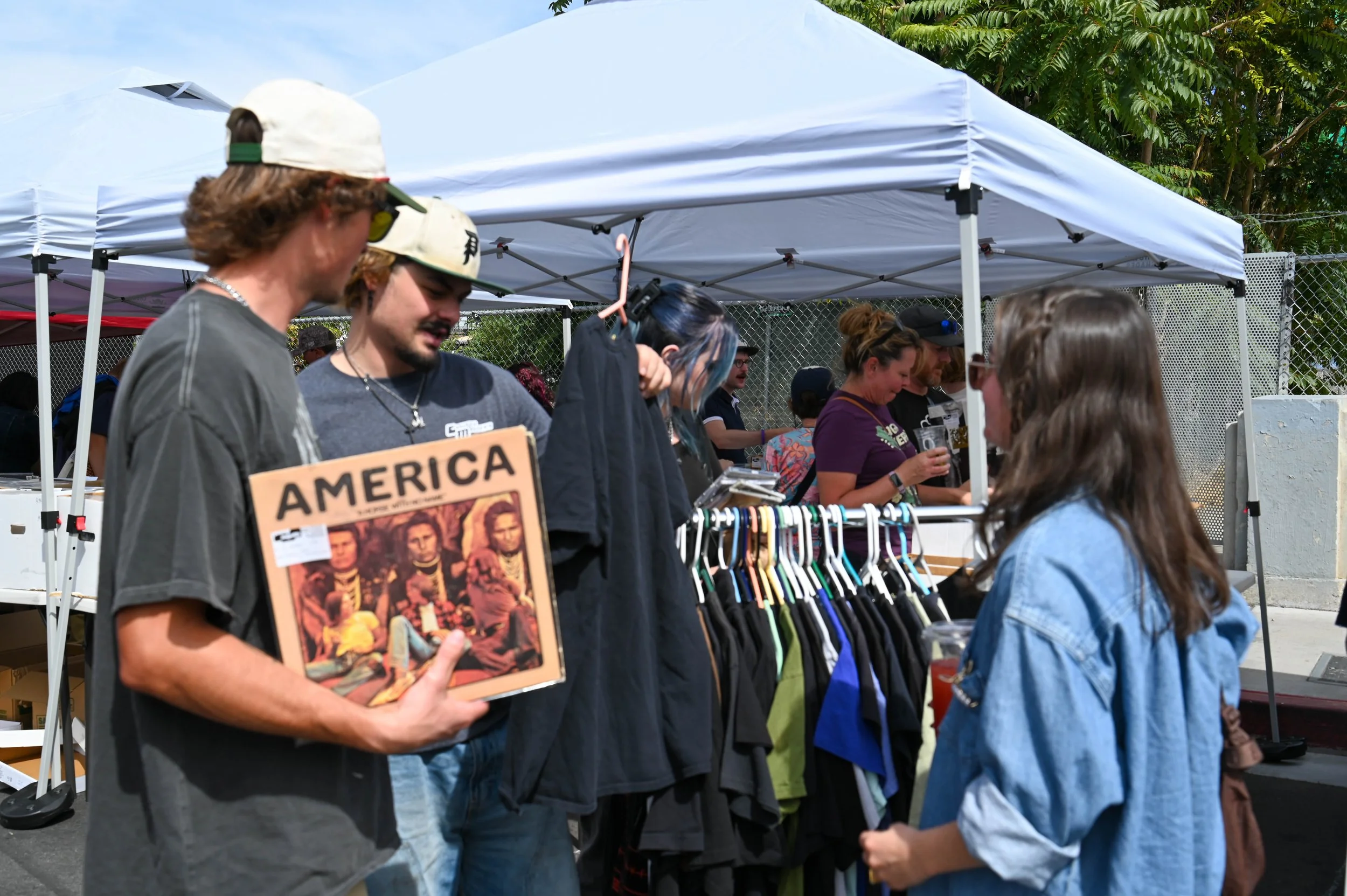 Part of the attraction is finding something unexpected. A shopper pauses with a vintage America record while looking through one of the booths.