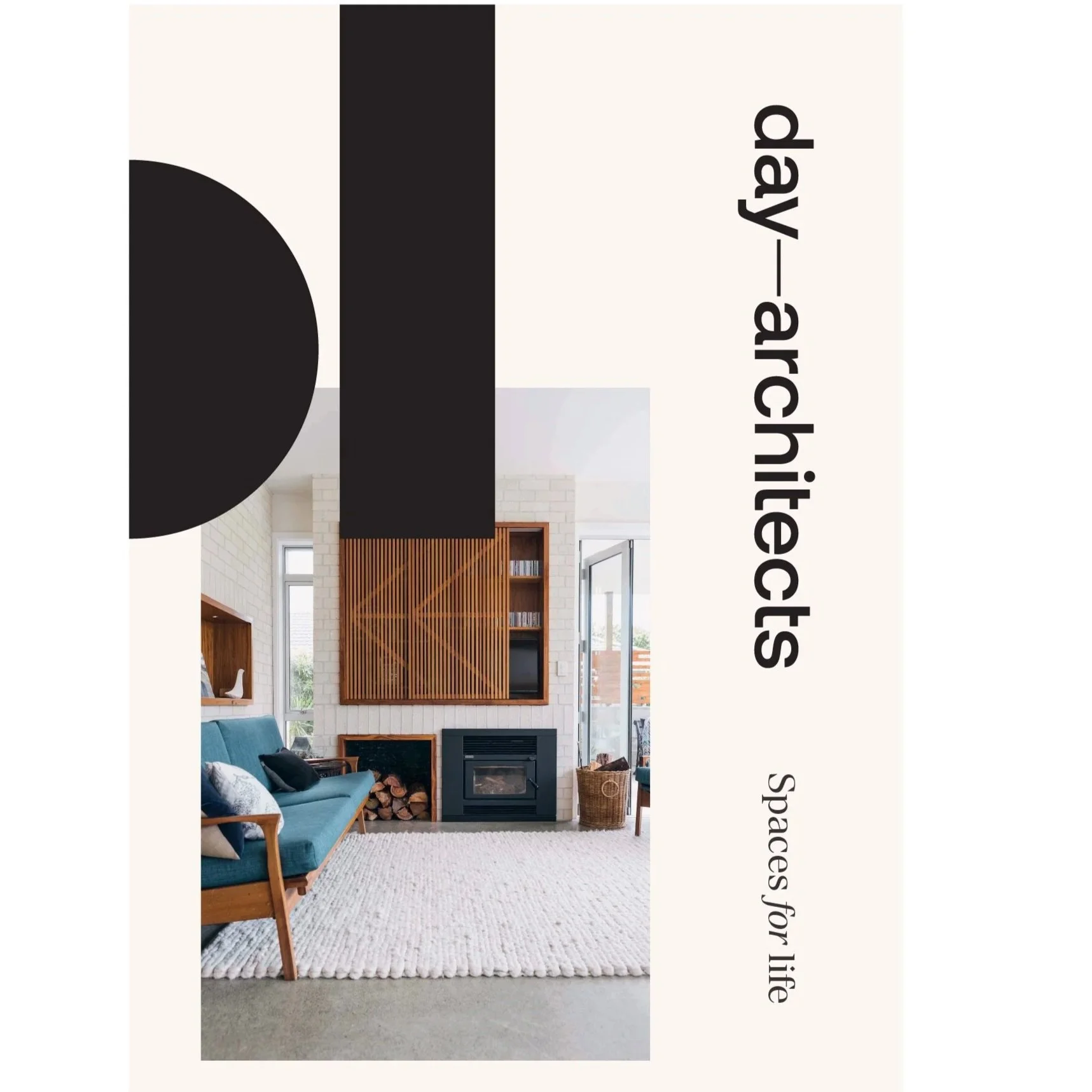 Day Architects specialise in site specific architecture designed for Life and land. Example shown of Living room with a teal sofa, wooden furniture, a fireplace with stacked logs, and wood slats on the wall. Large windows let in natural light.