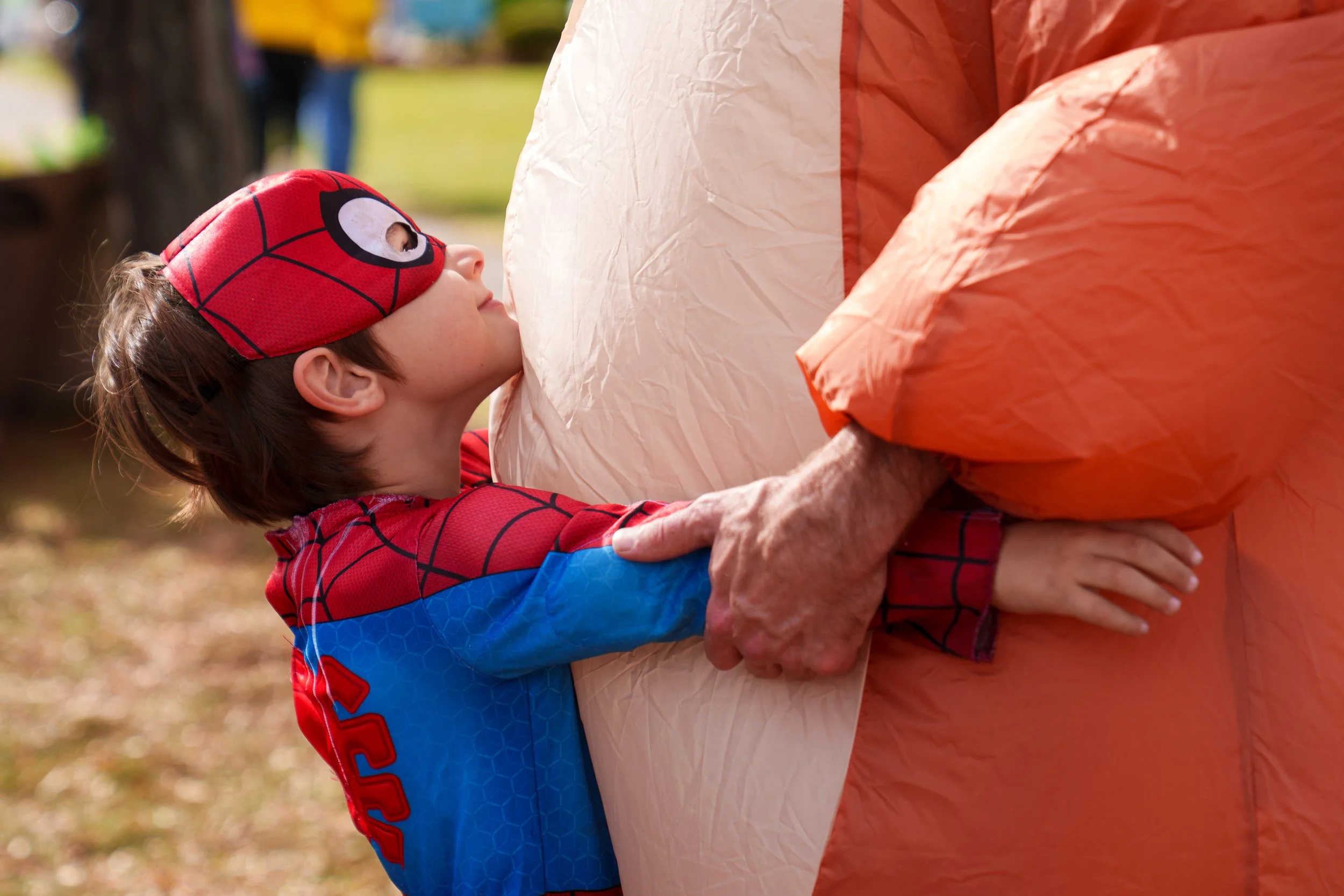 Ian King (left) hugs his father Brian King while dressed in his halloween costume to participate in the “No Kings: We’re Not Going Back” rally and march in downtown Rochester, a part of the nationwide “No Kings” day of protests against the Trump admi