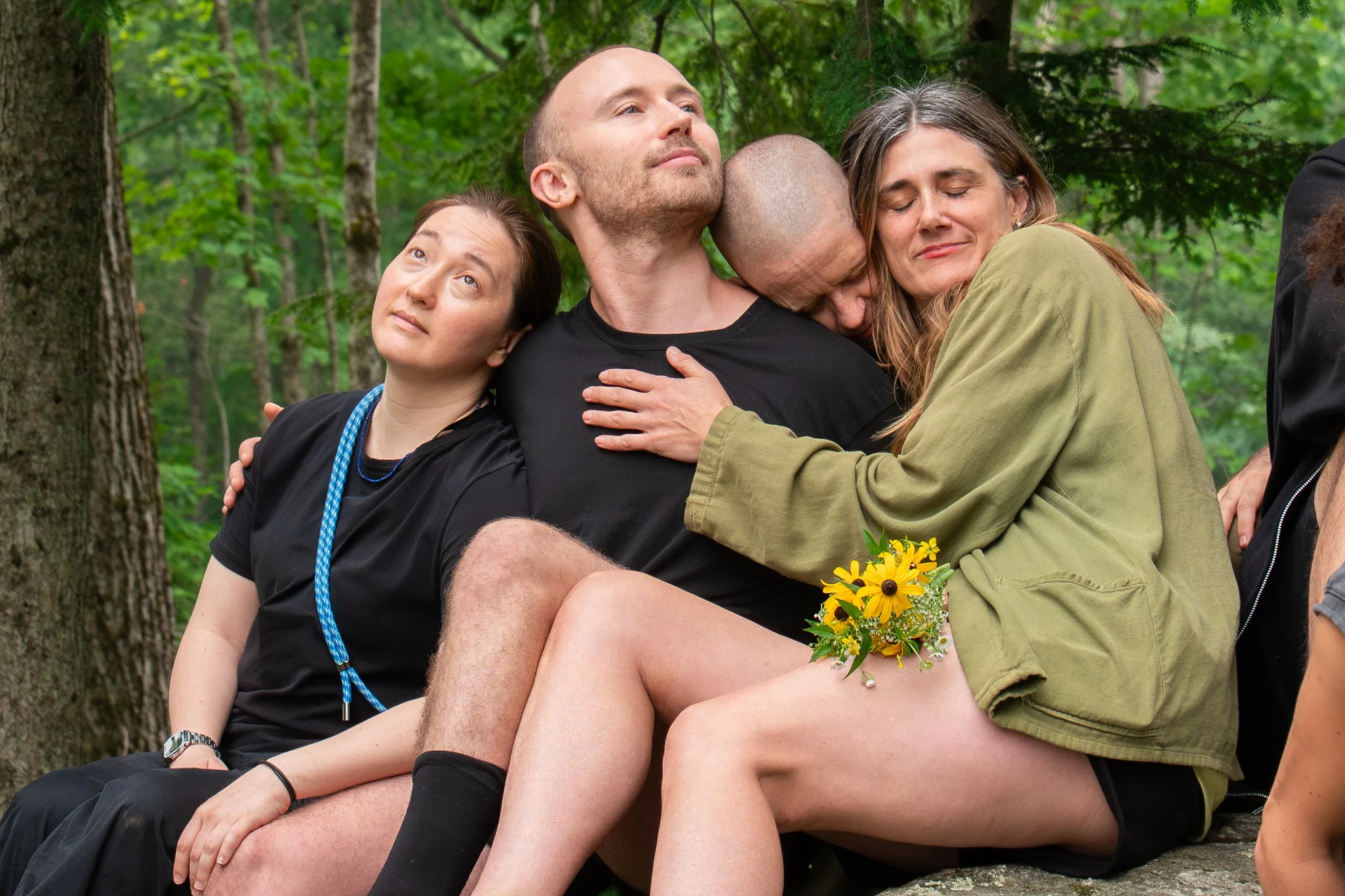 Choreographer Faye Driscoll embraces members of her company while sitting on the Pillow Rock at Jacob's Pillow Dance Festival in Becket, M.A., on July 15, 2026.