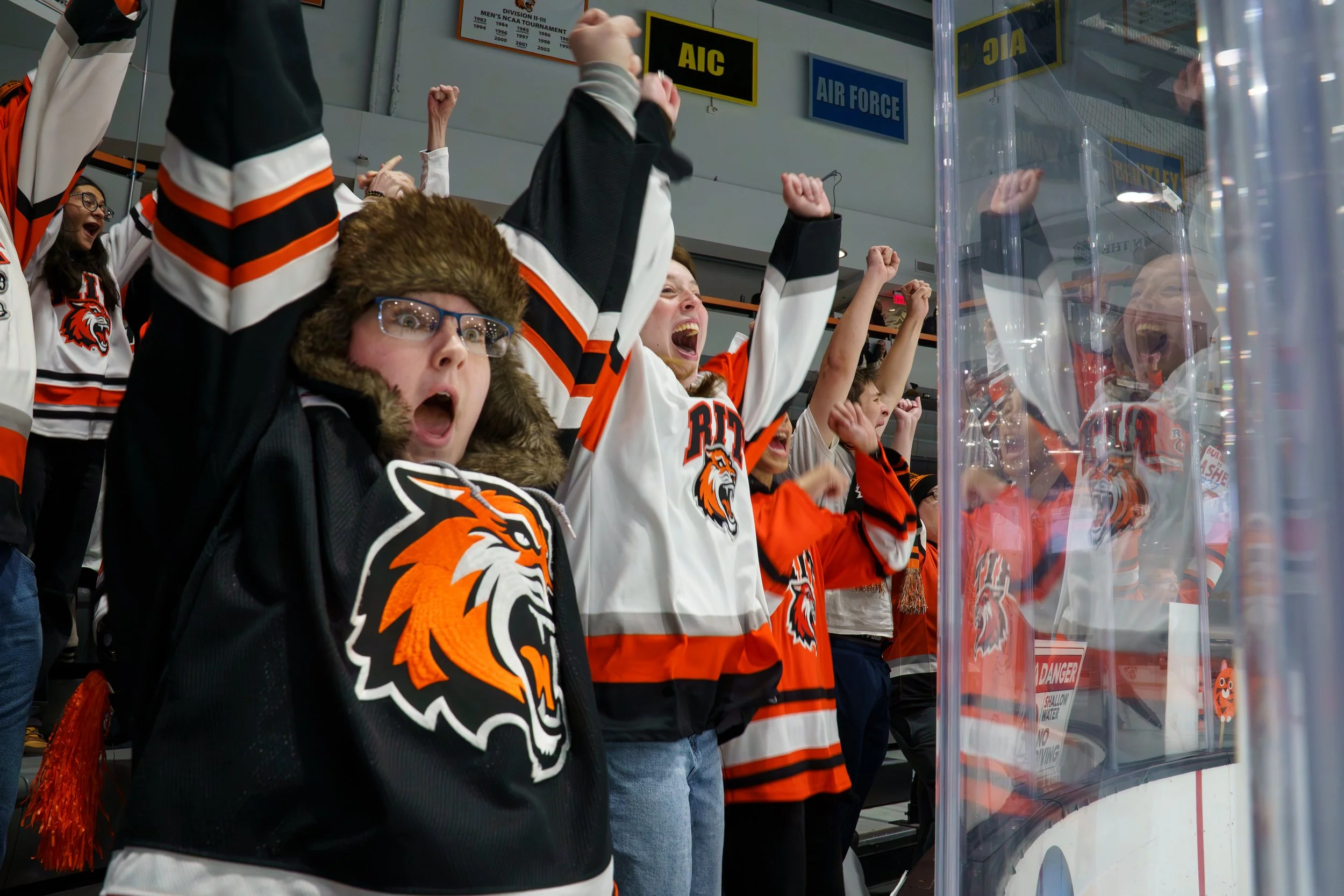 Rochester Institute of Technology student members of the Corner Crew celebrate after Tilli Keranen #28 scores a goal against Delaware at Gene Poliseni Center on Dec., 6, 2025 in Rochester, N.Y. The RIT Tigers beat Delaware with a 4-2 win.