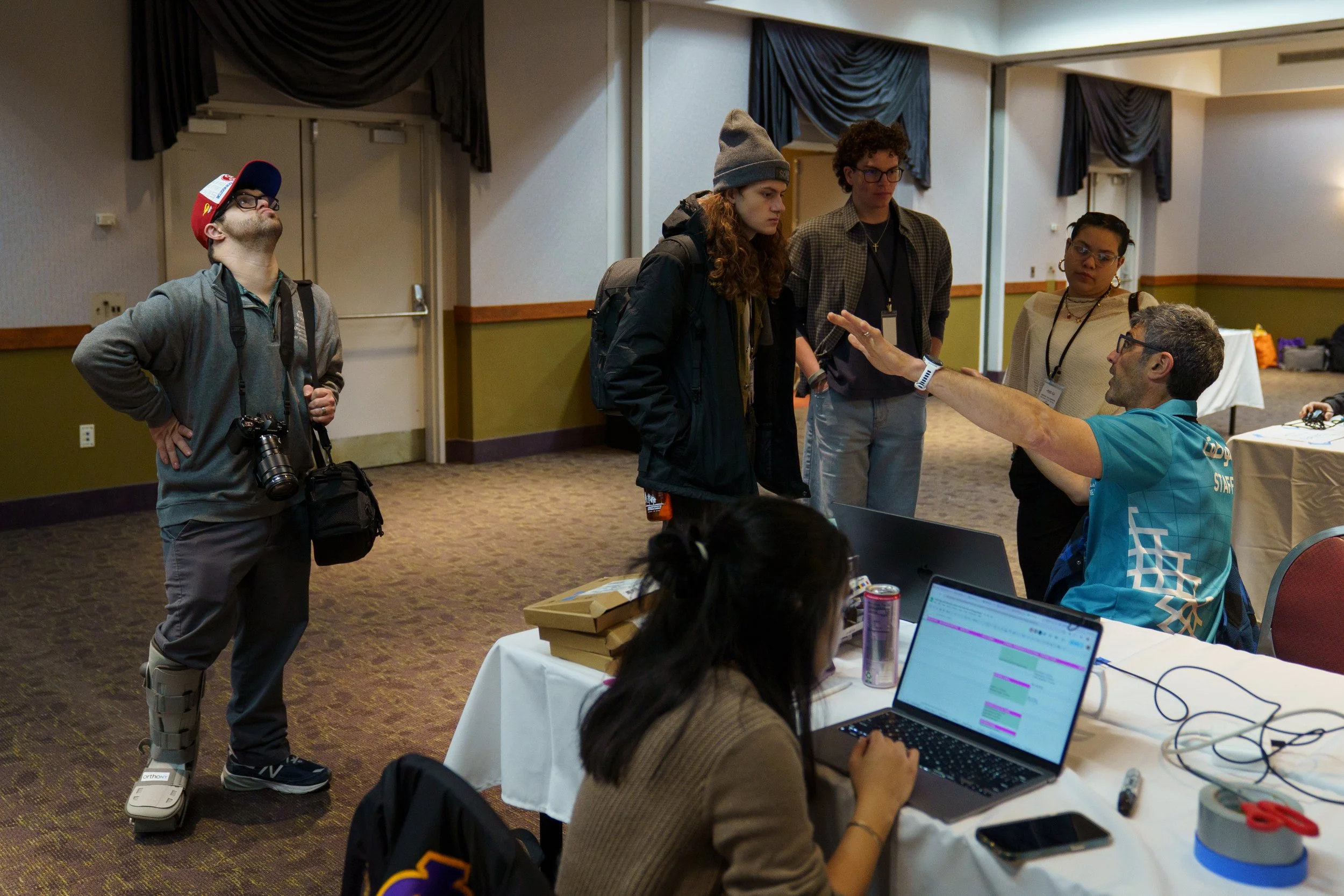 Jude Killar waits to talk to Rochester Institute of Technology faculty member Josh Meltzer while he speaks to other RIT students before the opening ceremonies at Joseph A. Floreano Rochester Riverside Convention Center in Rochester, N.Y. on Feb. 20, 