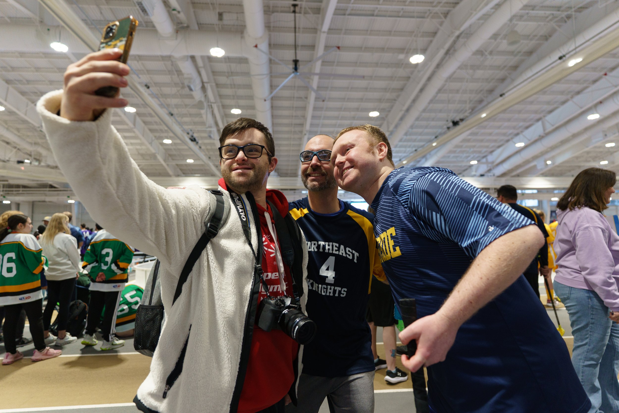 Jude Killar takes a selfie with his friends Will Smith (center) and Jacob Babcock (right) during floorball at Nazareth Golisano Training Center in Rochester, N.Y. on Feb. 21, 2026. Killar, Smith, and Babcock have all been friends for several years an