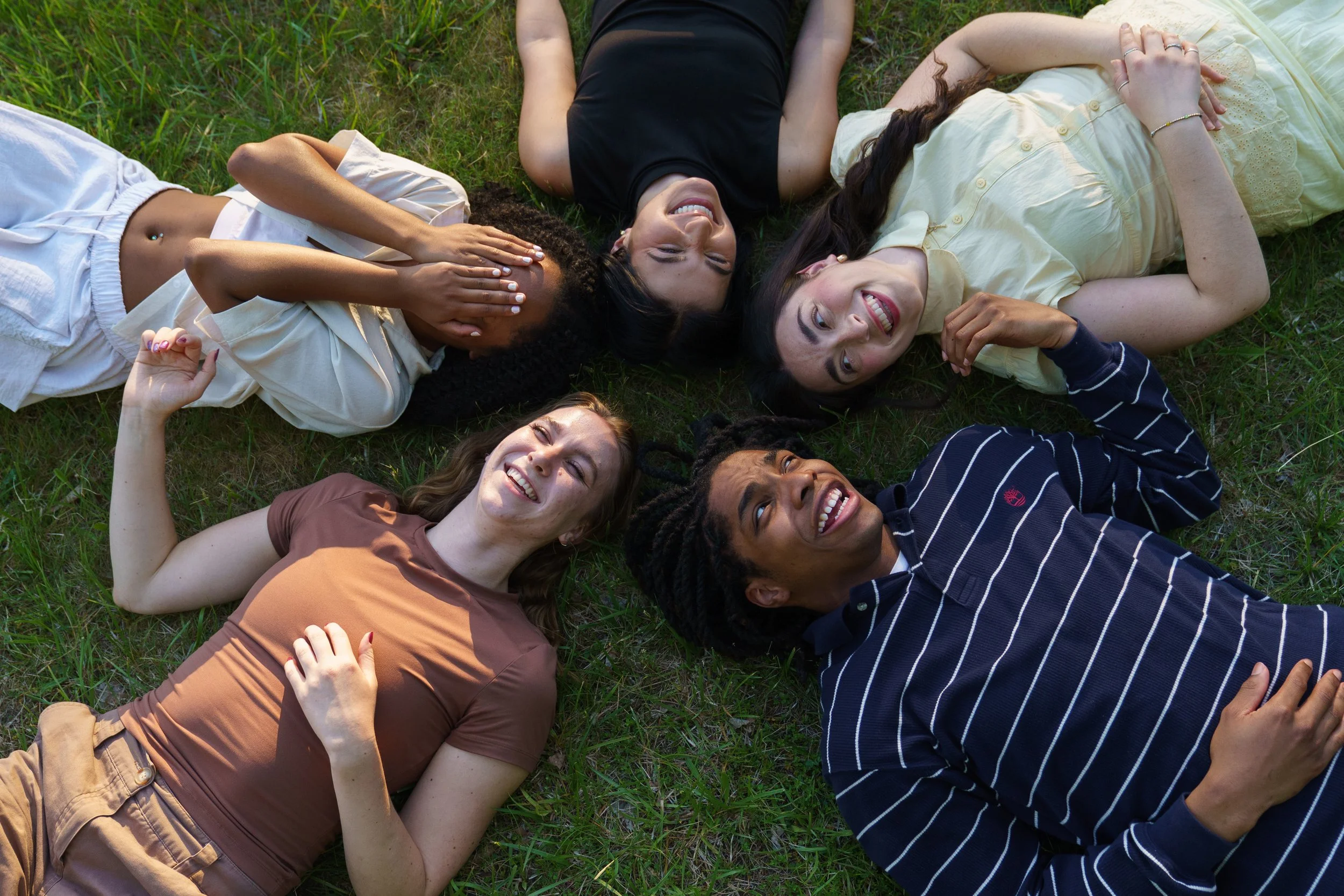 (Clockwise from bottom left) Shea Hancock, Aaryn Coleman, Gianna Dobrich, Victoria Isabel Piccolo, and Z Johnson lie on the ground during filming for Video Documentation Intern Nastia Yavorski’s dance music video on June 8, 2026.