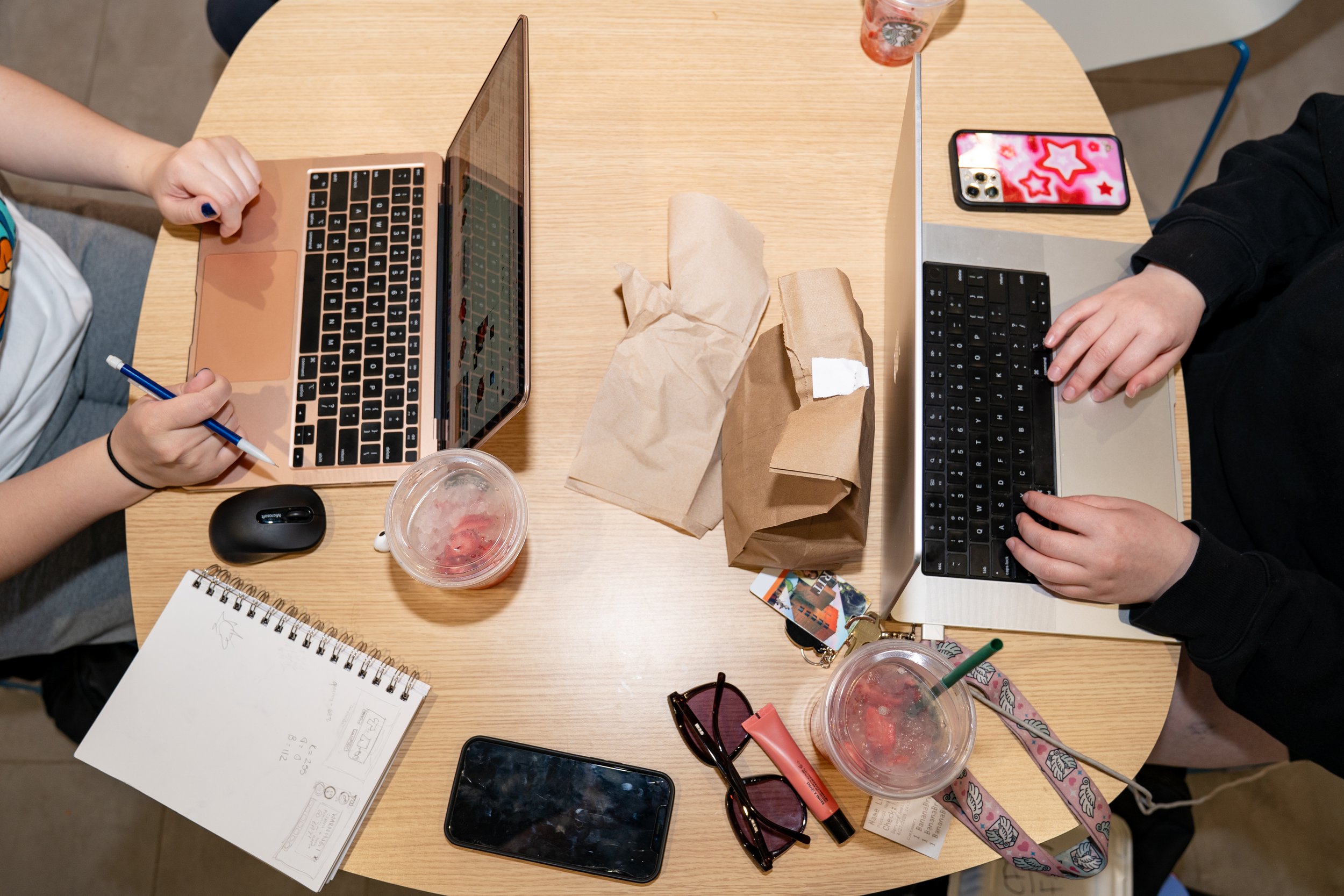 Madi (left) and Alicia (right) Gentes do homework together in Artesano’s Bakery and Cafe in Monroe Hall at Rochester Institute of Technology on Apr. 27, 2025 in Rochester, N.Y. Although Alicia is two years older than Madi, they are both majoring in g