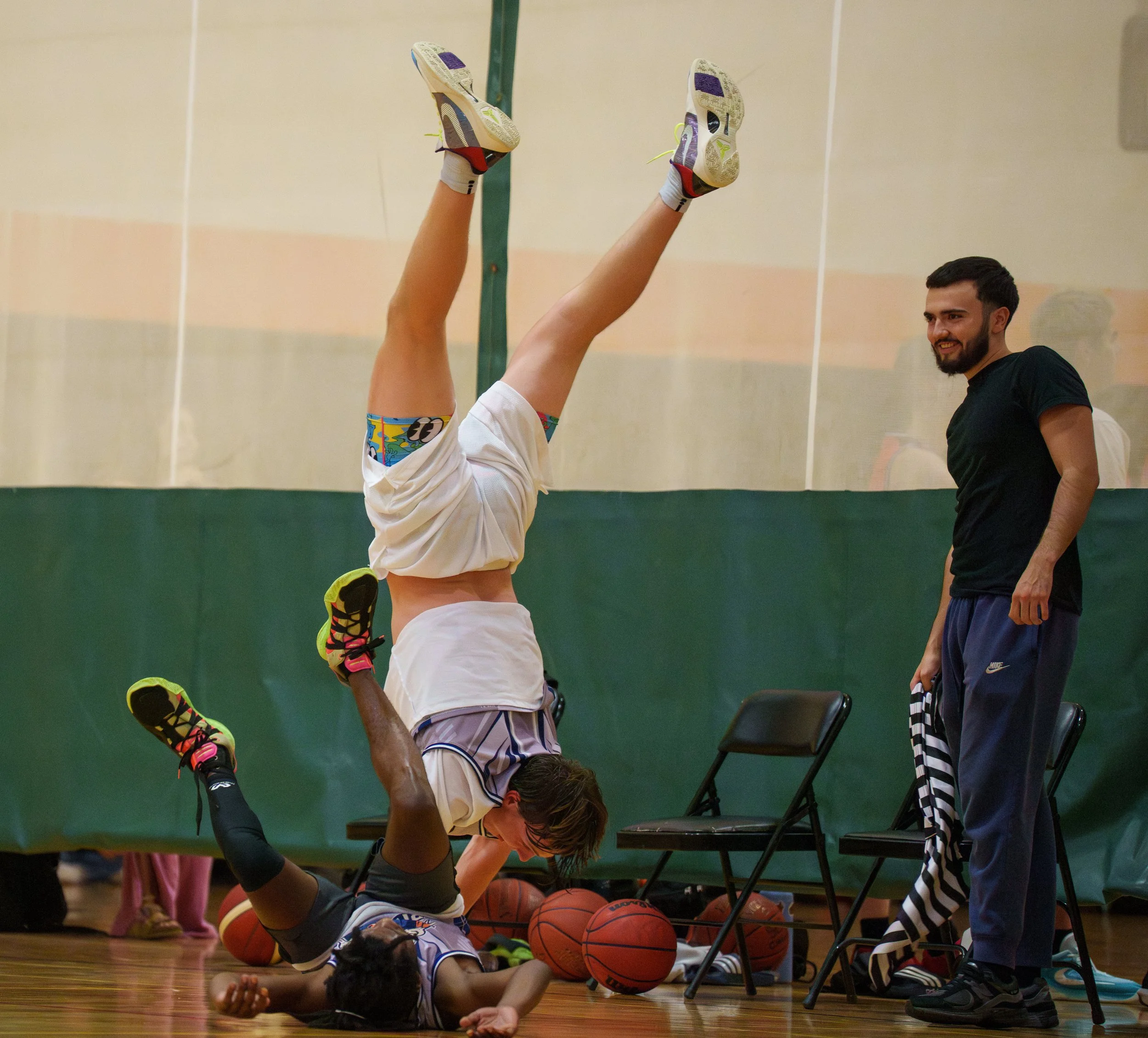 Rochester Institute of Technology student Jared Huseby does a celebration handstand after making a basket during his Deaf Basketball Association game against Brick Mafia in the Hale Andrews Student Life Center on Sept. 19, 2025 in Rochester, N.Y. 