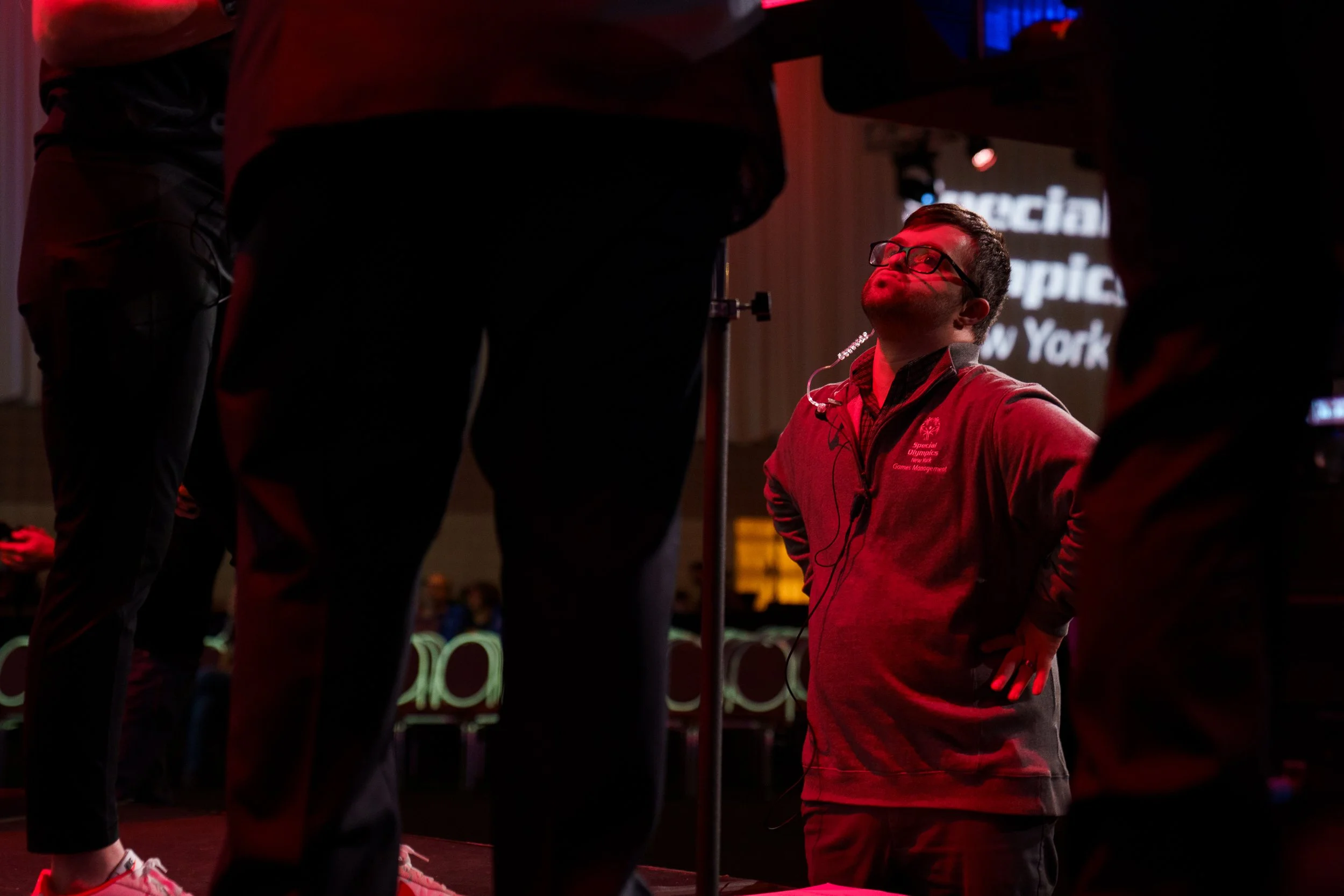 Jude Killar listens Stacy Eder (far left) speak with DJ Naps before the opening ceremonies at Joseph A. Floreano Rochester Riverside Convention Center in Rochester, N.Y. on Feb. 20, 2026. Killar and Eder co-ran the opening ceremonies together, and Ki