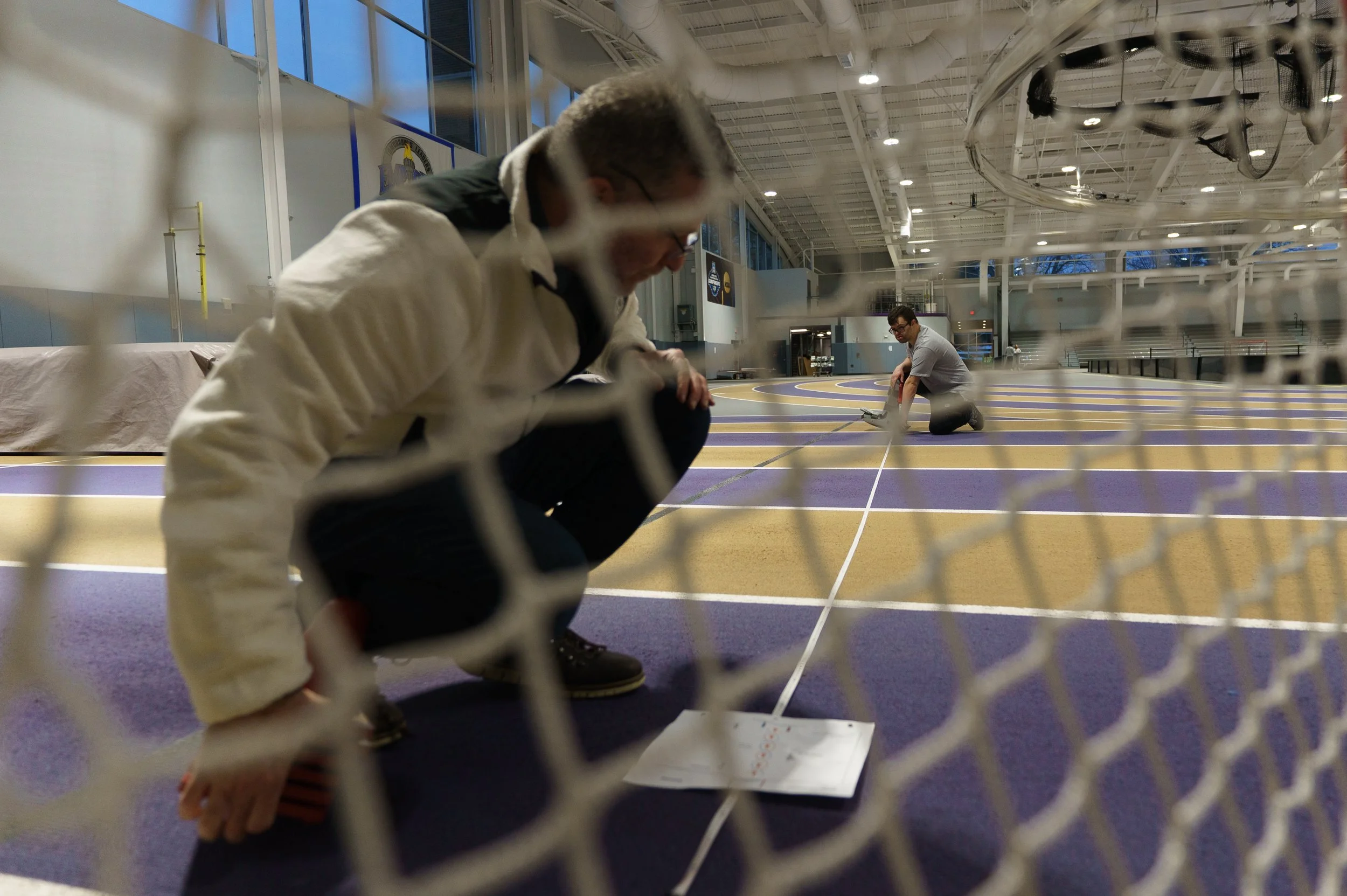 Jude Killar (right) helps Rami Aizenman (left) set up areas for athletes to compete floor ball skills at Golisano Training Center in Rochester, N.Y. on Feb. 21, 2026.