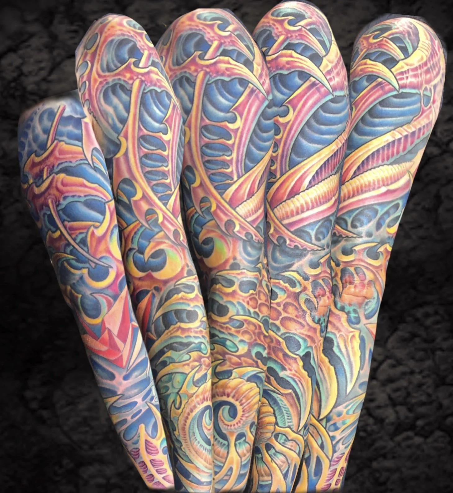 Close-up of a hand with colorful, intricate octopus and ocean wave tattoo artwork covering multiple fingers and hand surface.