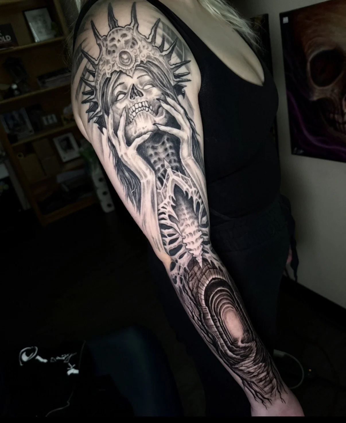 Black and gray tattoo sleeve featuring a woman's face with long hair, skull, cosmic and galaxy elements, and a serpent or dragon.