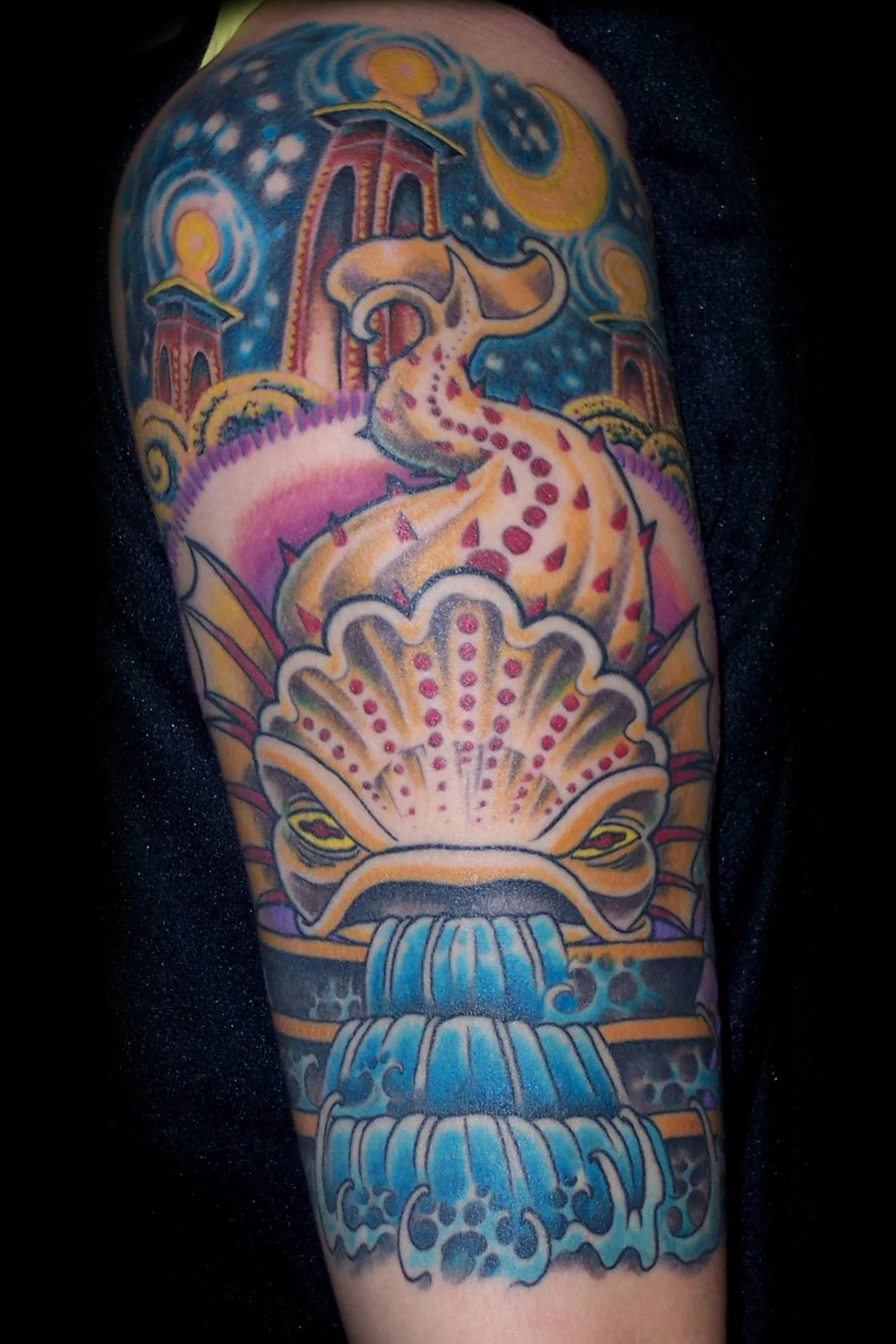 Colorful tattoo of a dragon flowing from a fountain with water, with a background of a starry sky, moons, and temples.
